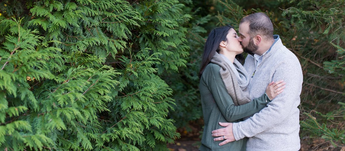 Husband and Wife kissing in a winter family session in White Plains, NY Photo