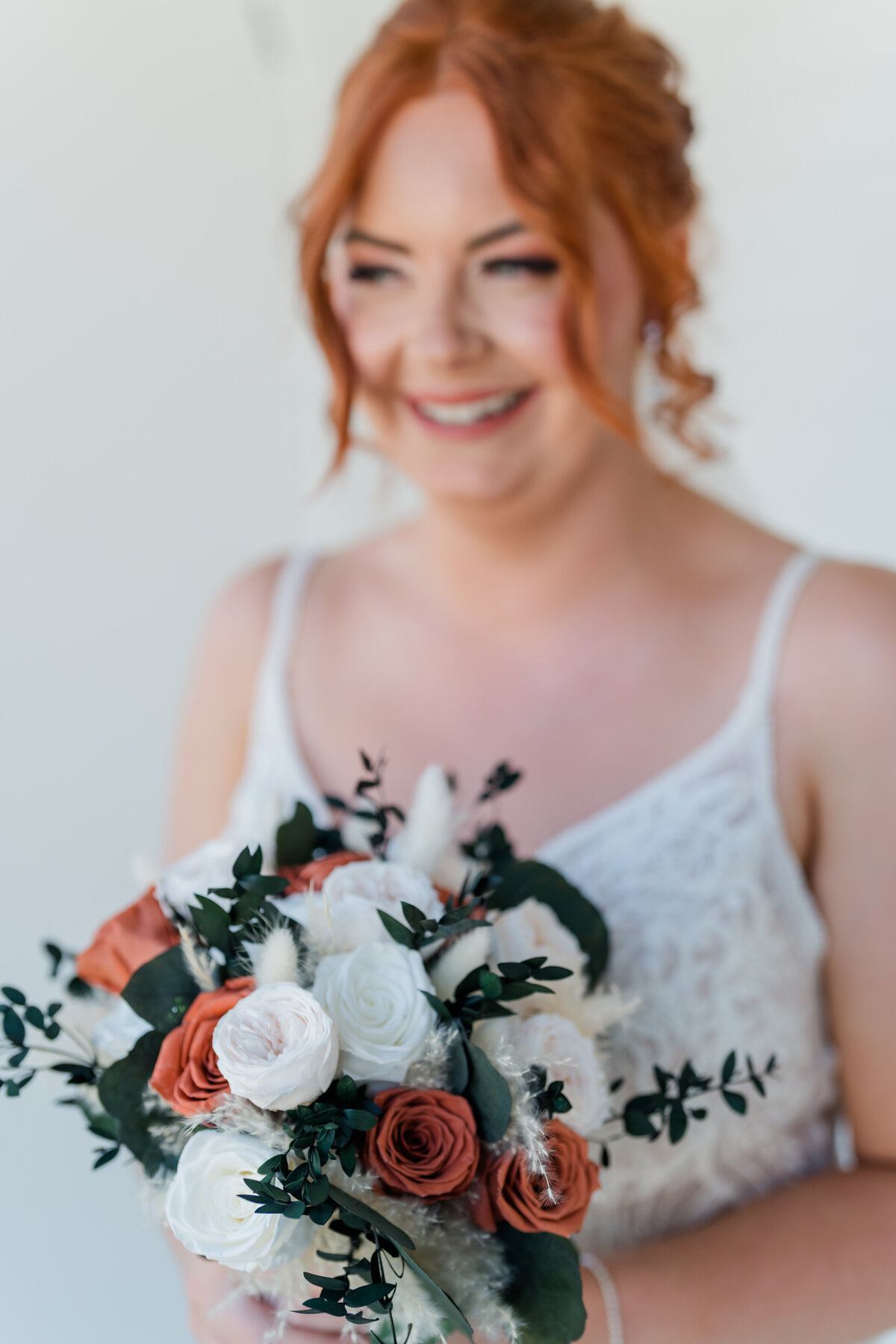 Bride laughing on her wedding day in gunning