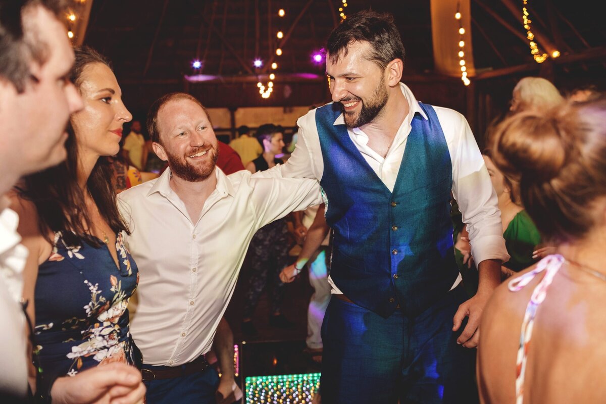 Groom dancing with guests at wedding in Riviera Maya