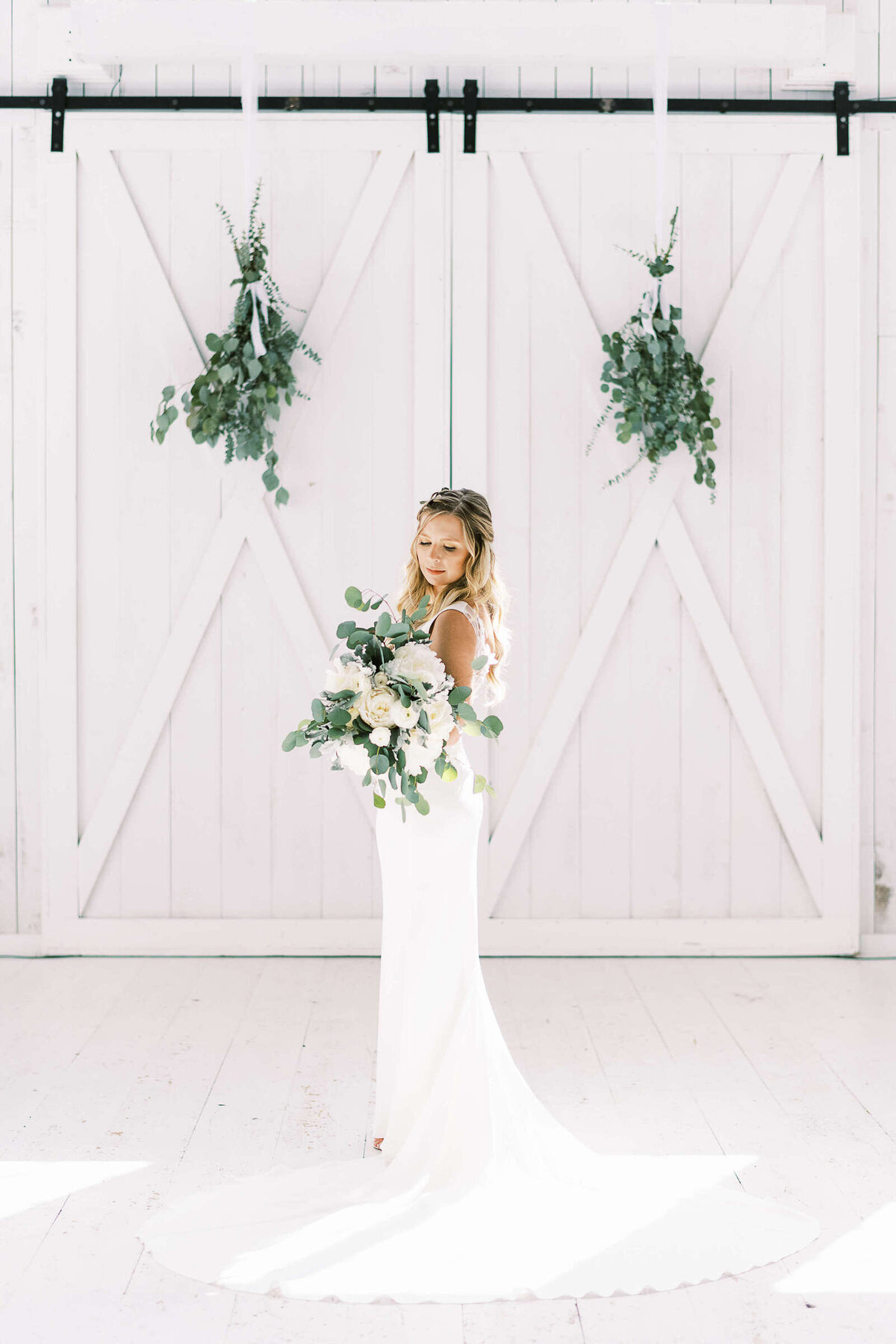 Classy simple bridals with greenery and white barn doors in North Texas