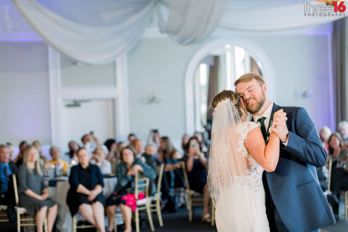 Bride and Groom dance cheek to cheek at their reception