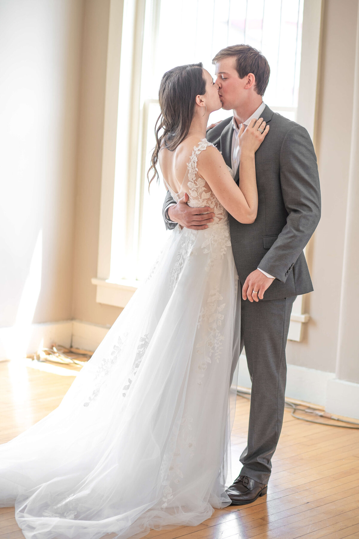 Couple cuddled up and kissing inside a venue,