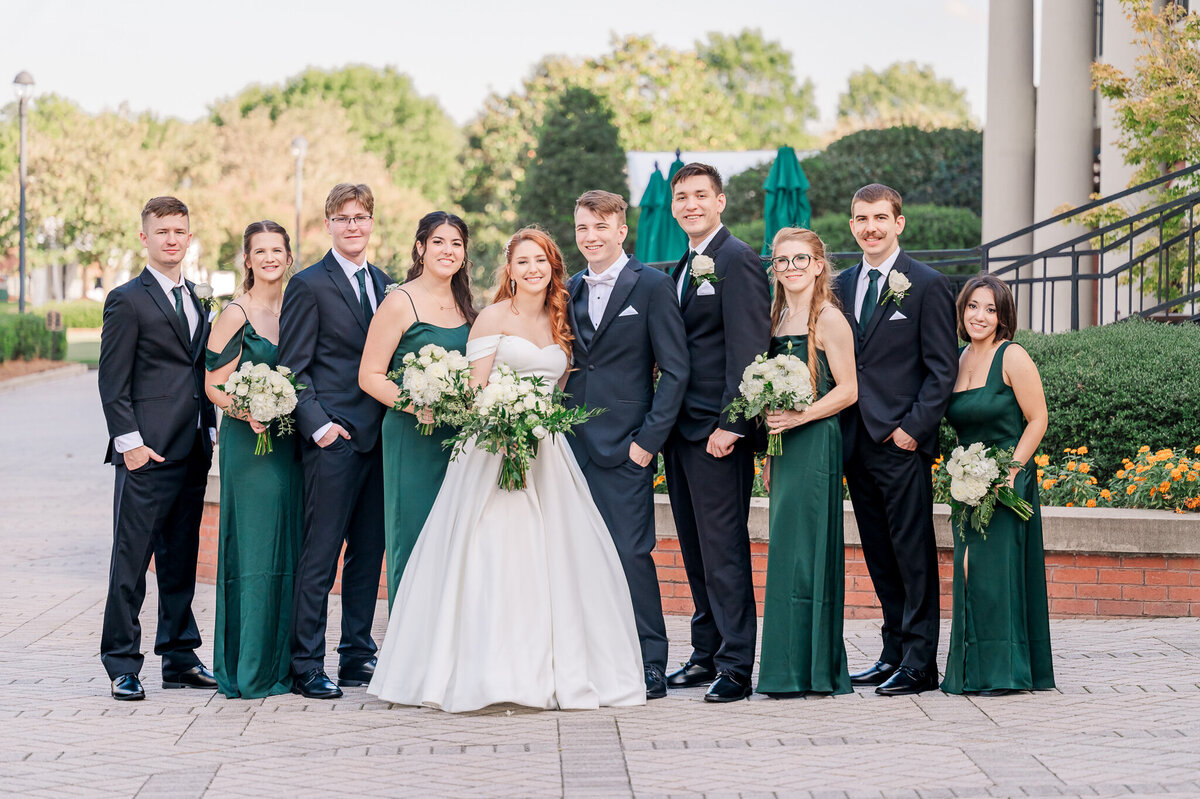 A wedding party in Cary dressed in green and black on a fall afternoon in Cary by Raleigh wedding photographer, JoLynn Photography