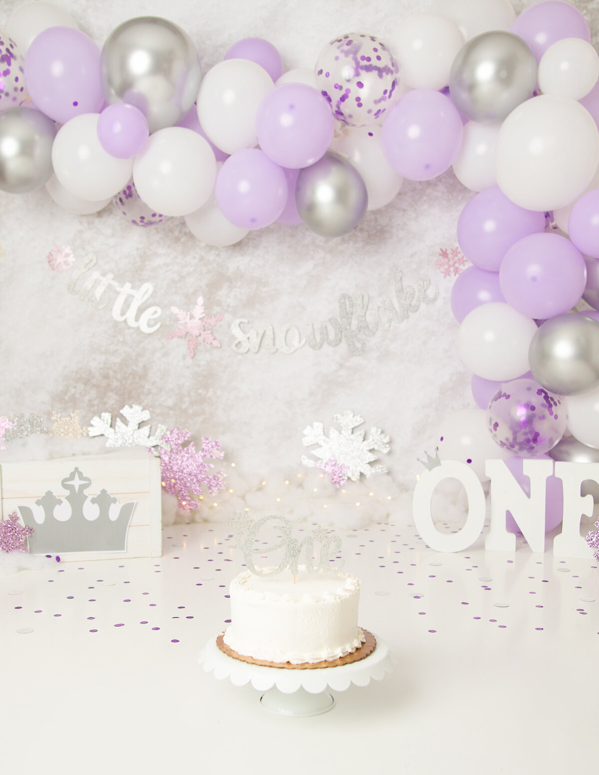Celebrating a first birthday with a winter wonderland themed cake smash in Rochester, NY.