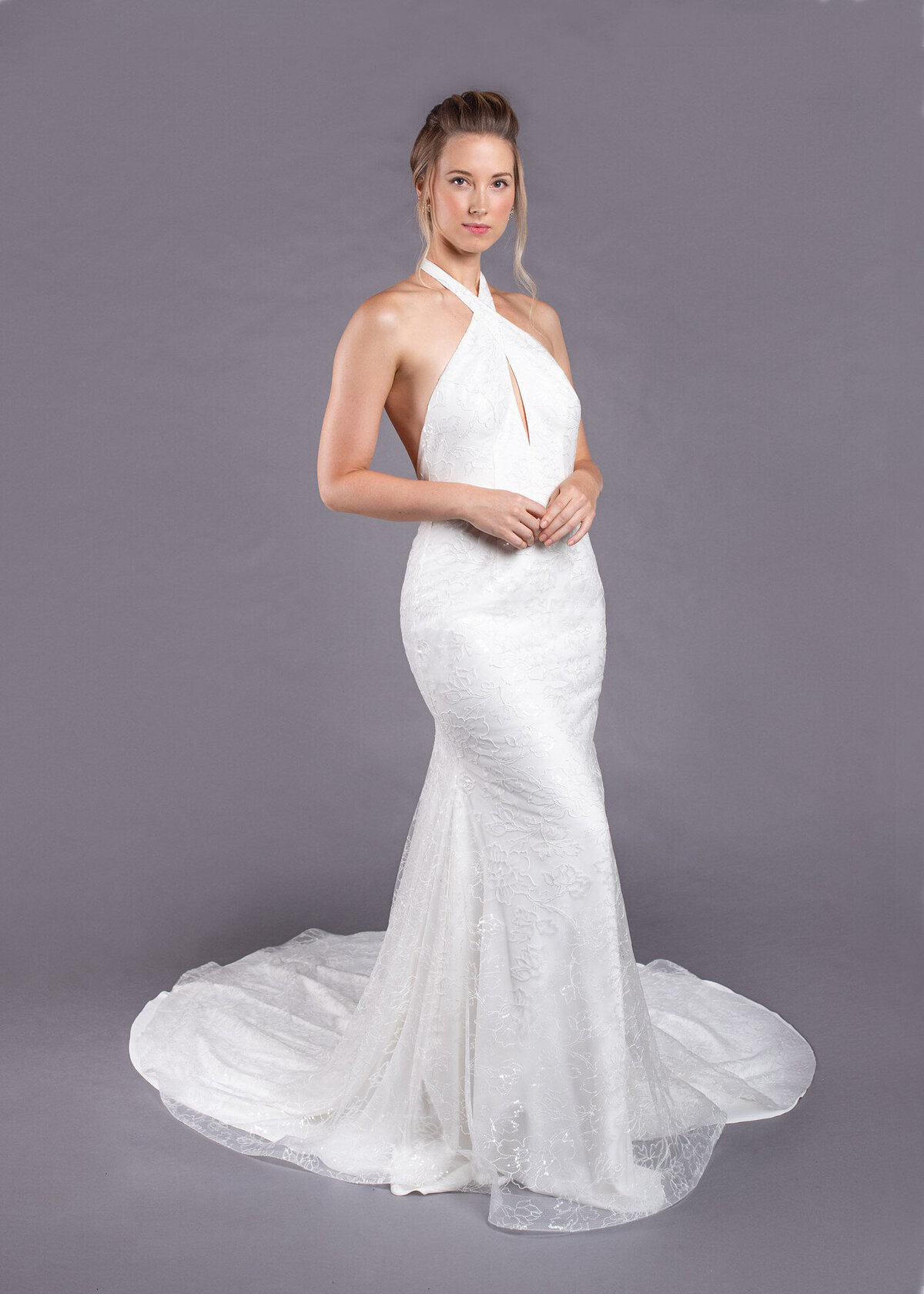 The Marlene bridal style by Edith Elan is a halter mermaid wedding dress with a sparkly floral lace layer on top of crepe.