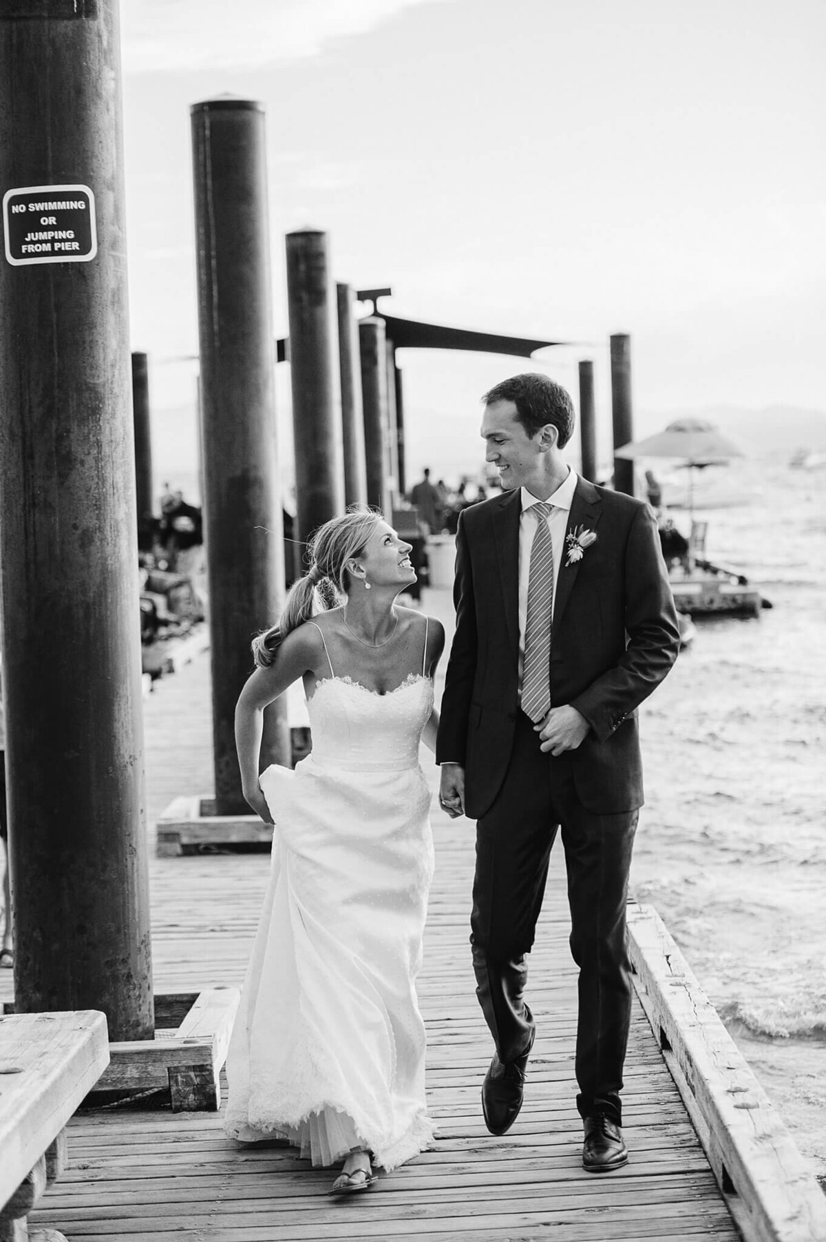 Newlyweds on pier Hyatt Tahoe black and white film image