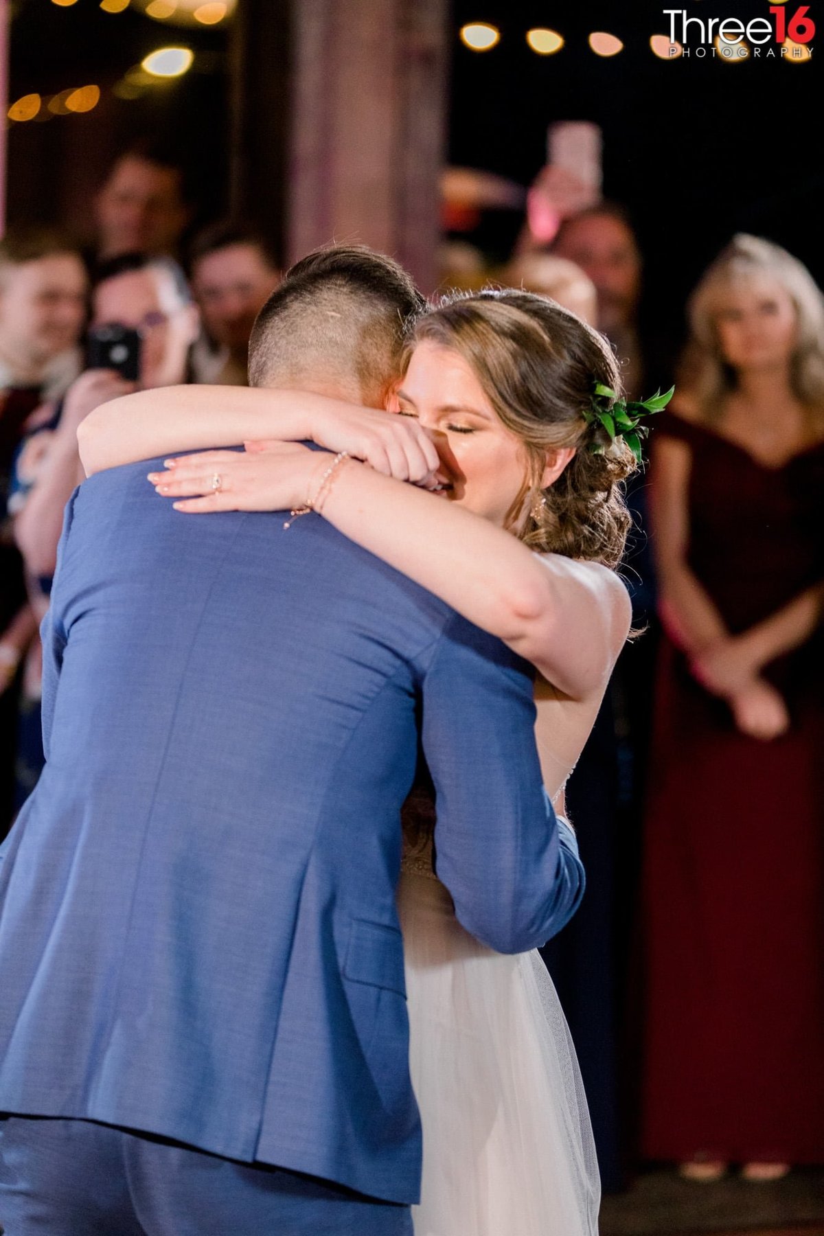 Newly married couple embrace during their first dance