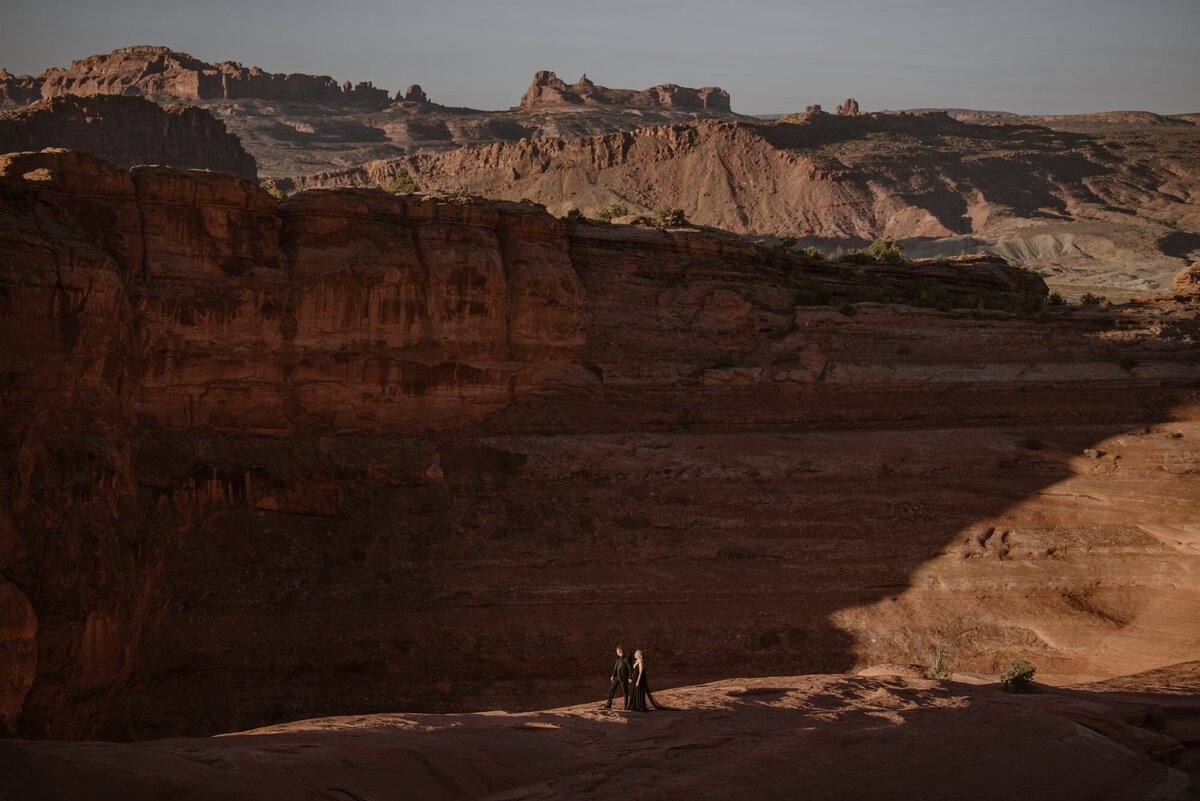 Couple hiking through Arches National Park on their wedding day
