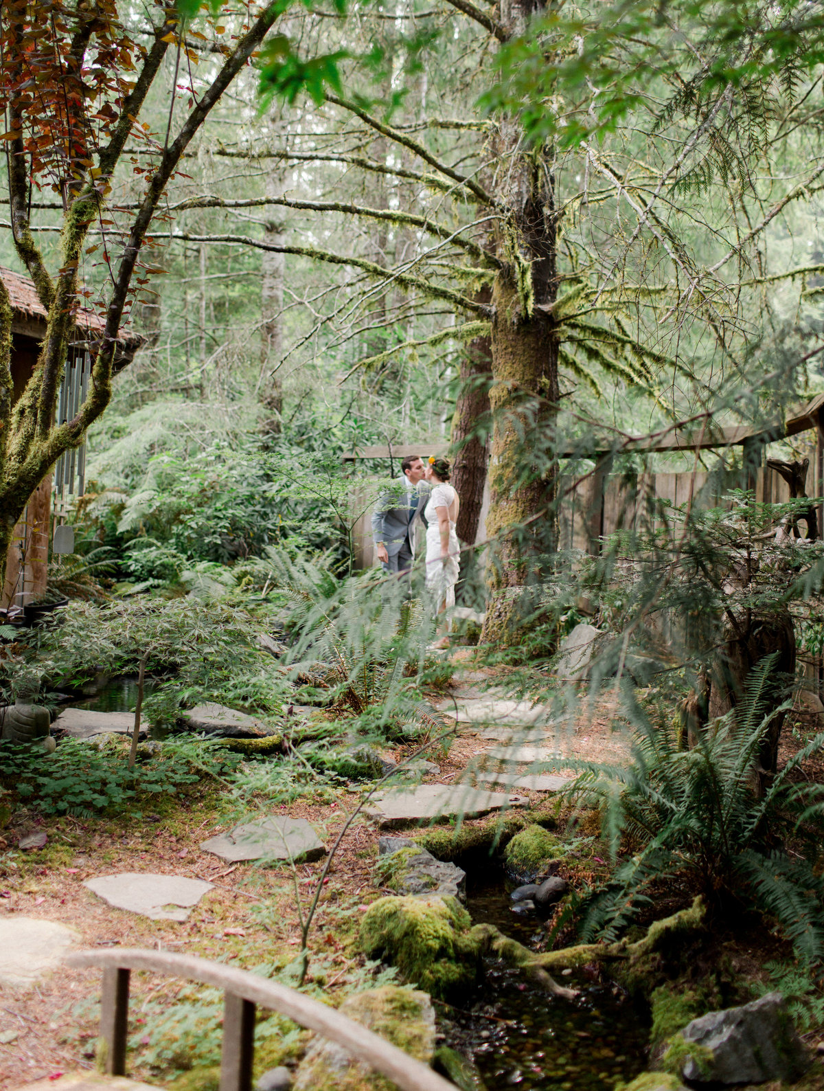 bride and groom see each other for first time among garden path in washington forest