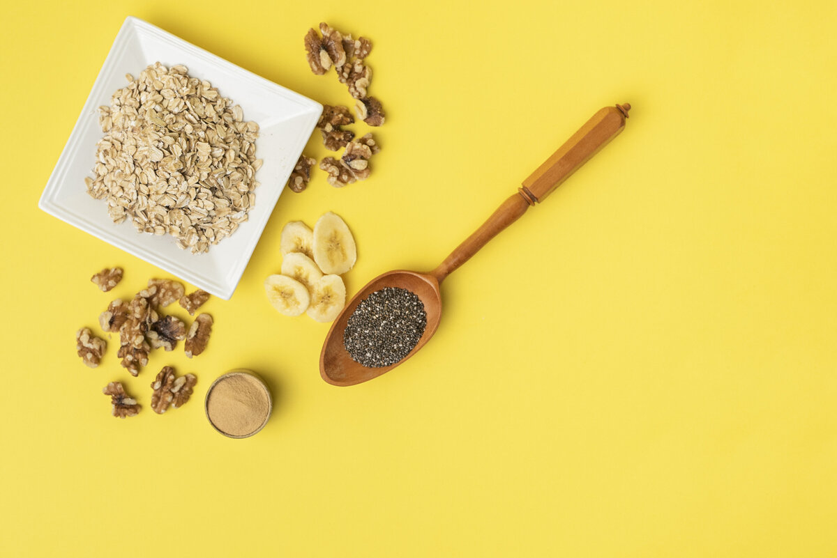 Overnight oats ingredients laid out on yellow table