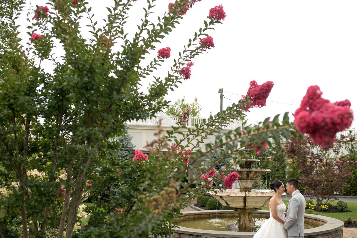 Bride and groom holding hands in front of the fountain at Bridgeview