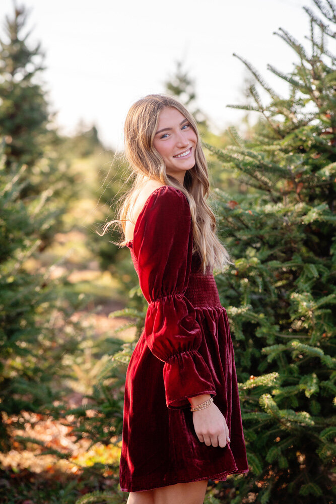 Young woman wearing a red dress during senior session