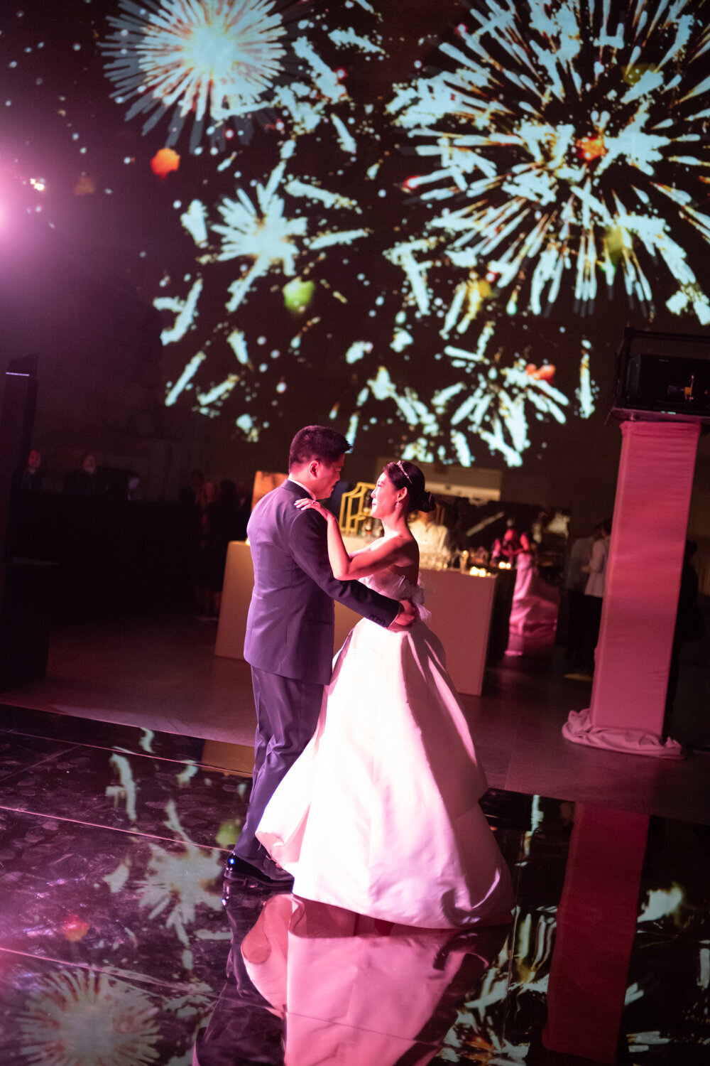 Bride and groom dancing with fireworks at the metropolitan museum of art