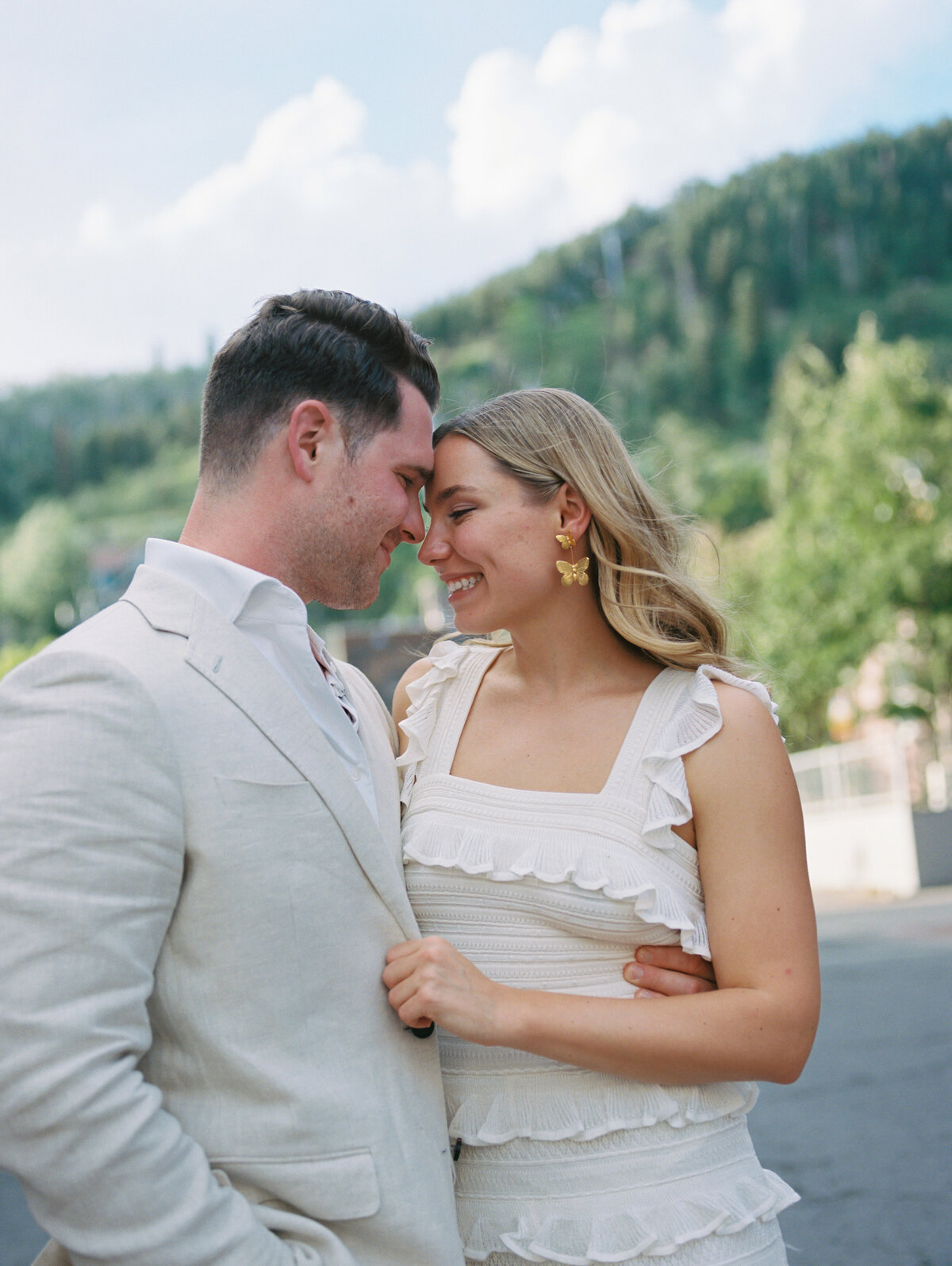 engaged couple embrace in downtown park city