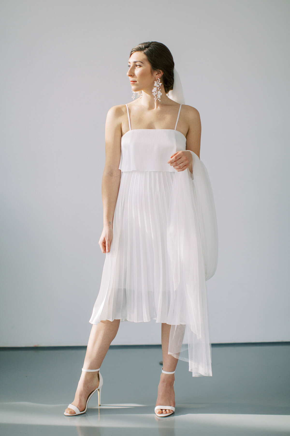 Classic and feminine whit pleated elopement dress By Catalfo, elegant wedding fashion based in Kelowna. Featured on the Brontë Bride Vendor Guide.