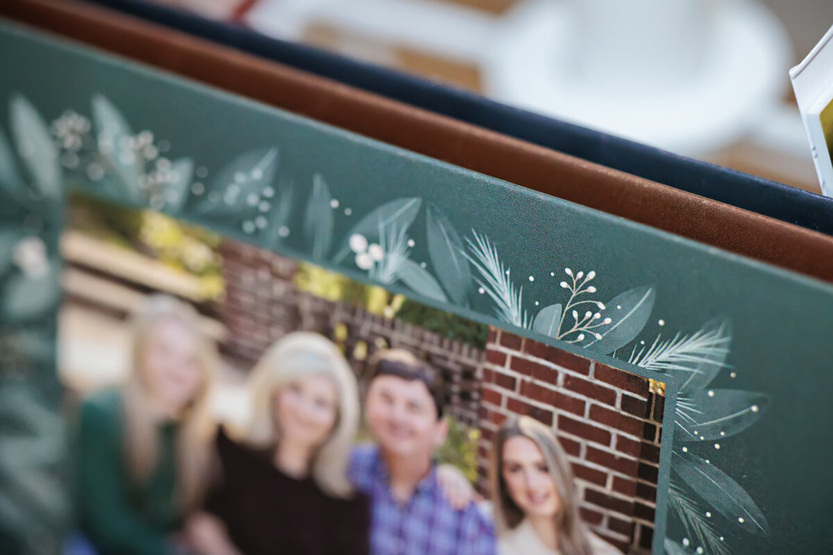Close-up of a stack of custom press printed holiday cards highlighting the shimmer and texture of pearl paper, showcasing premium print quality and elegant seasonal design details.