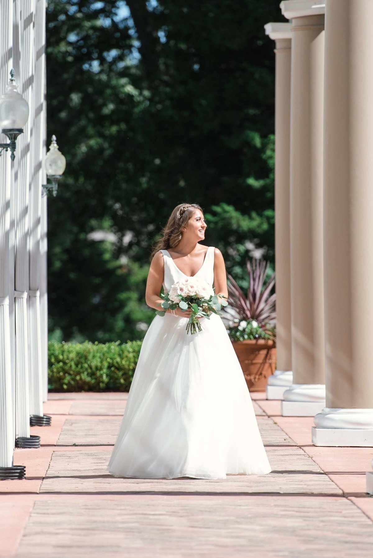 Bride alone on side of the outdoor reception area at Stonebridge Country Club