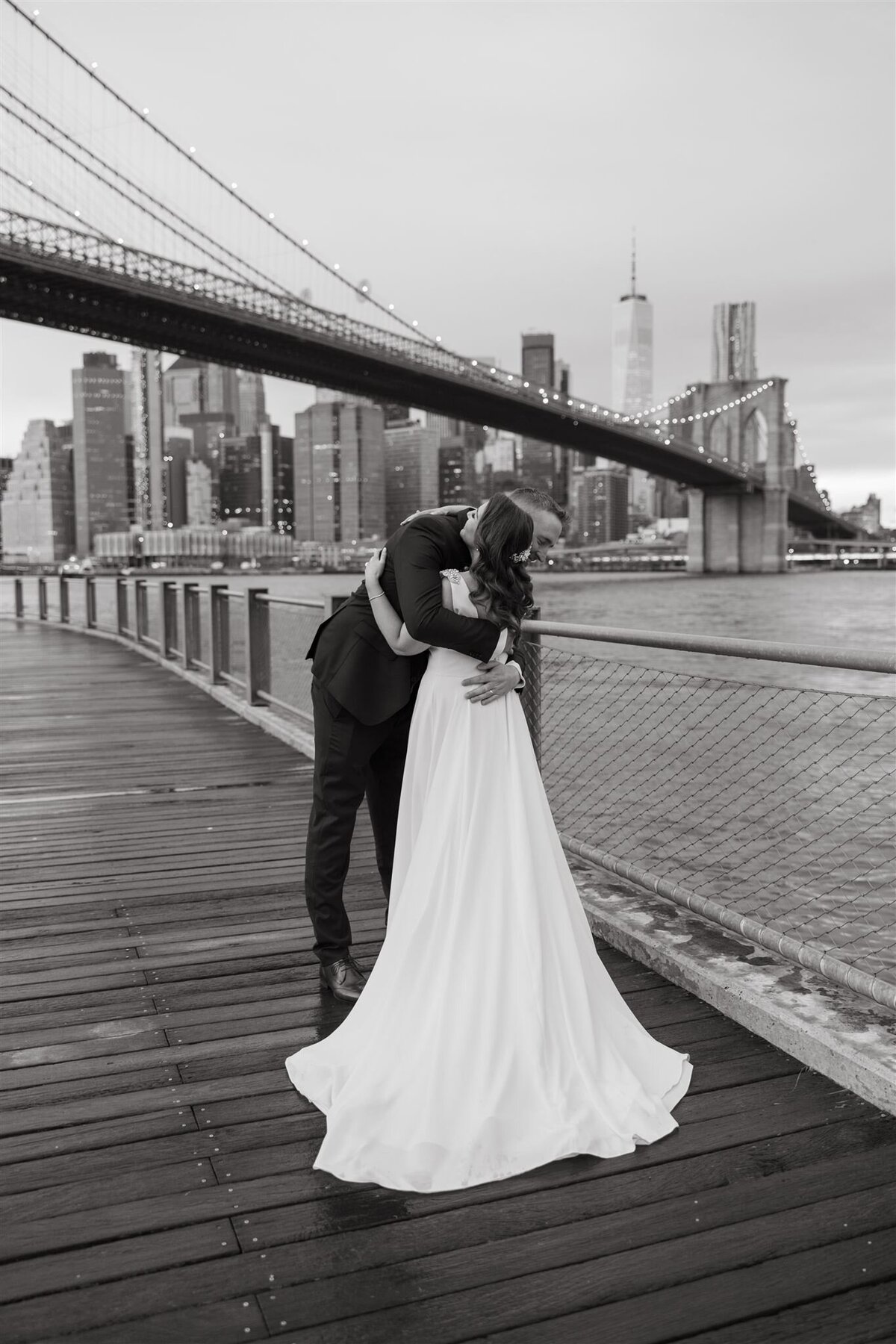 couple hugging on bridge in nyc