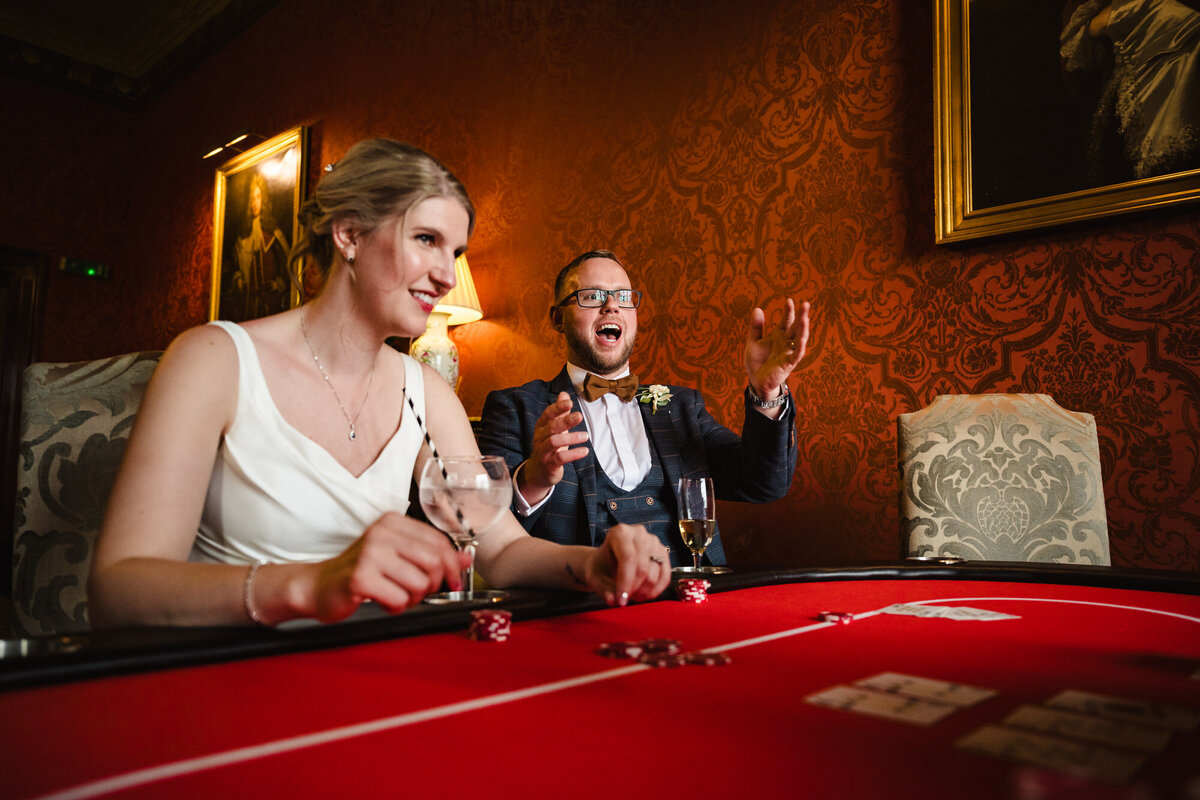 bride and groom playing poker at stapleford park hotel