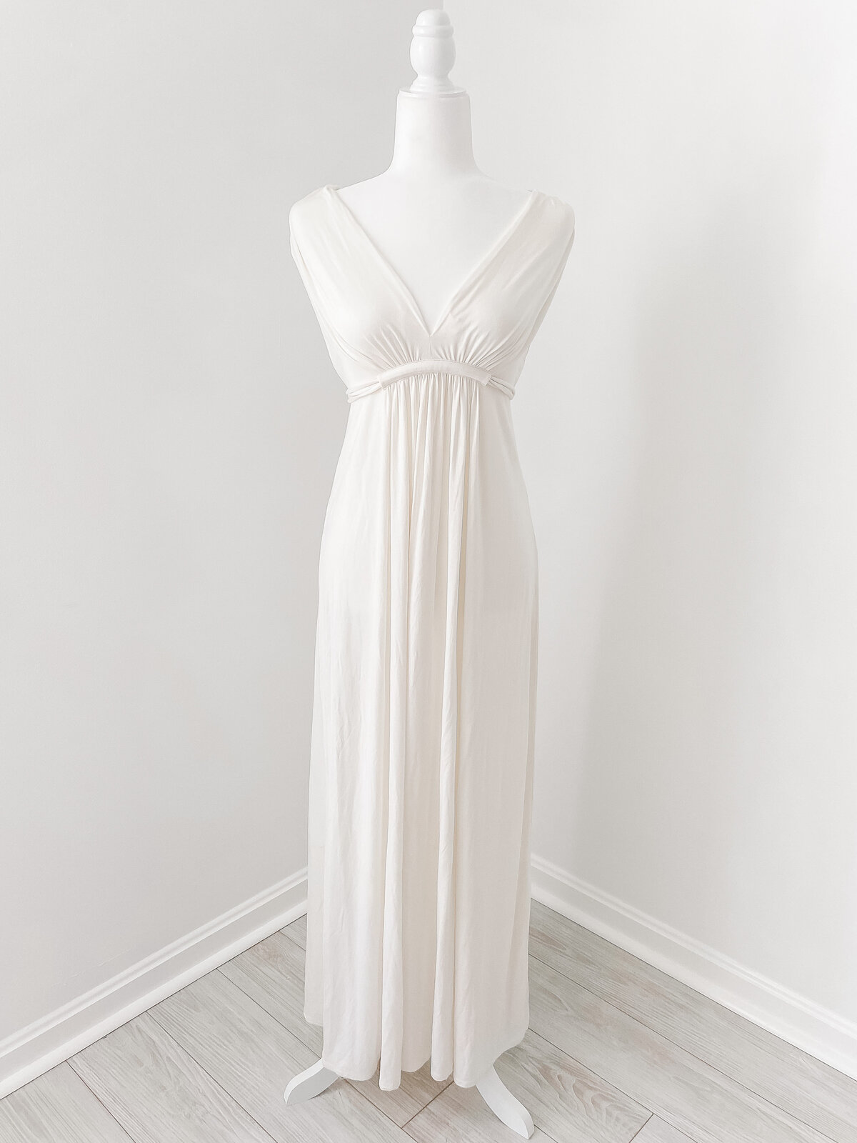 A cream maxi dress without sleeves and an empire waist by Washington DC Photographer