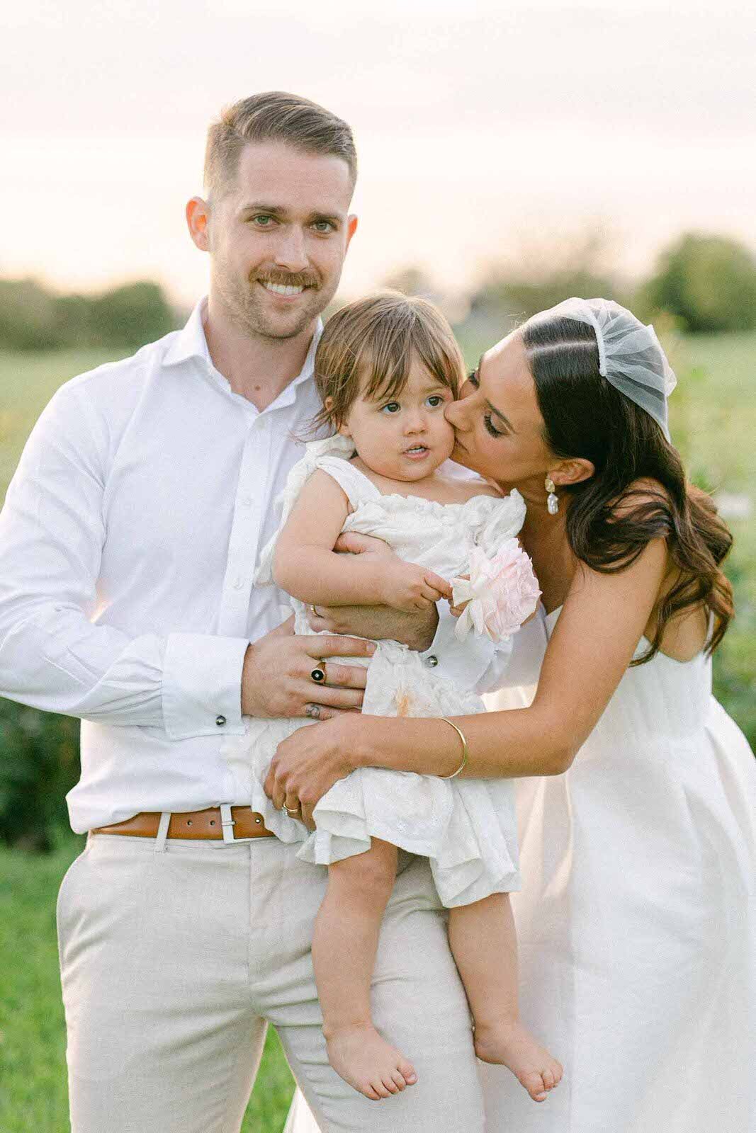 wedding couple with their daughter