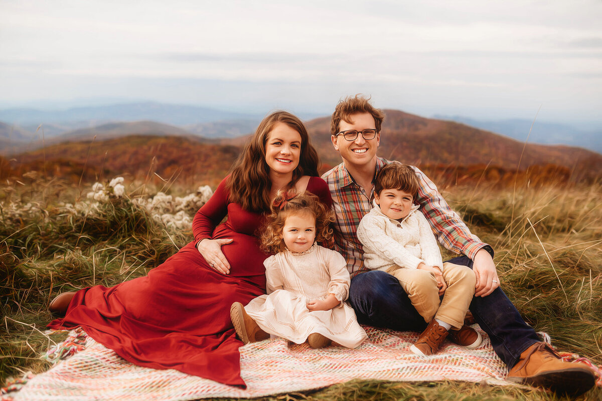 Family poses for portraits during Family Photoshoot at Max Patch in Asheville, NC.