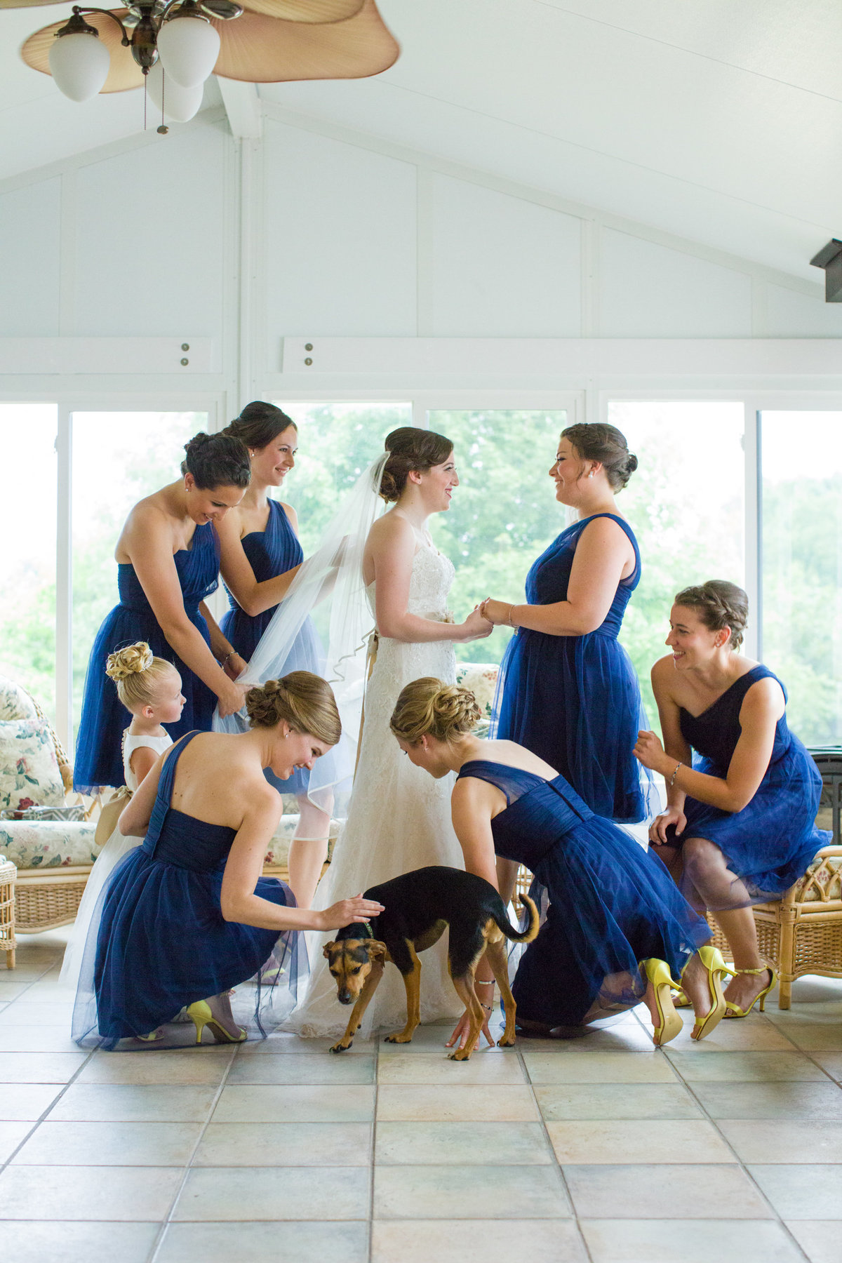 bridesmaids and bride with dog getting ready for wedding