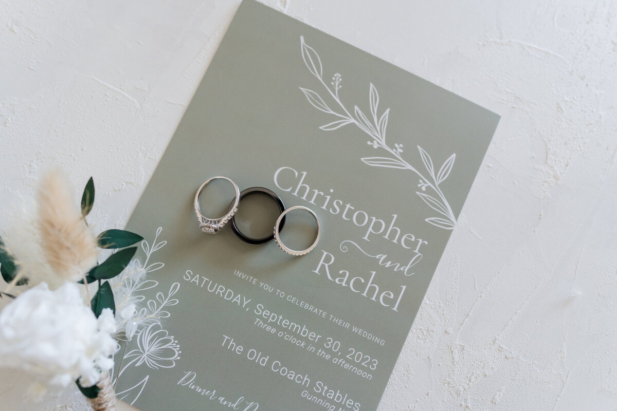 Bride and groom sage wedding invitation and rings