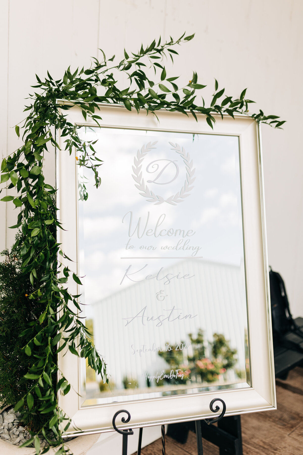 Mirror with greenery welcoming wedding guests