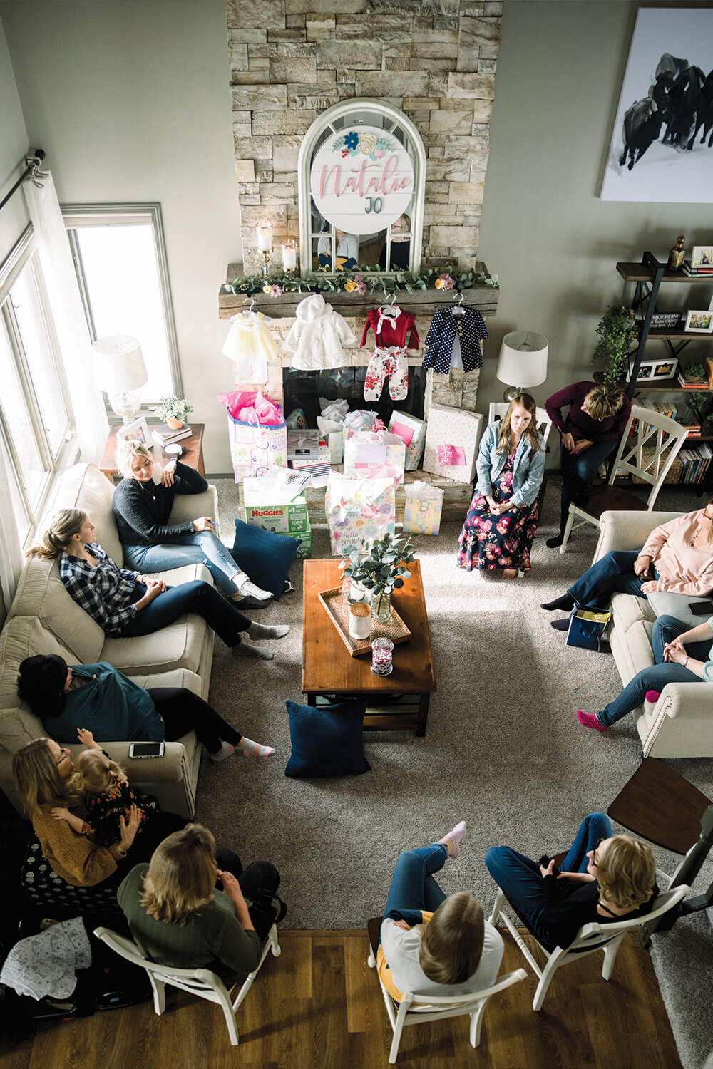 Guests enjoying the pink and yellow-themed girl baby shower, engaging in conversation and celebrating together.
