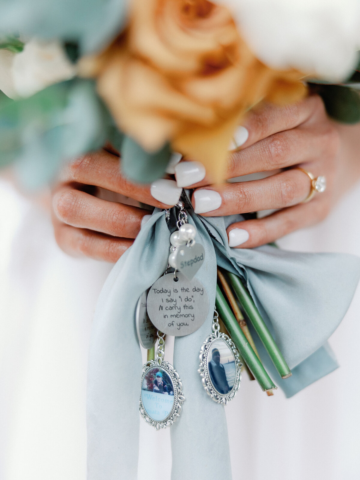 A close up of the brides bouquet which has a dedication charm for her passed grandmother