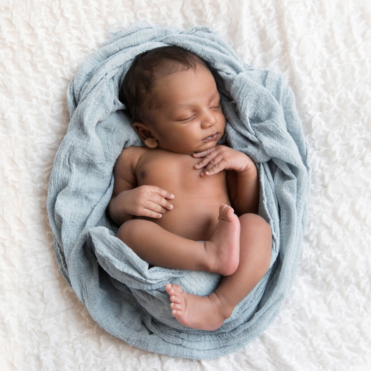 newborn-baby-wrapped-in-blue