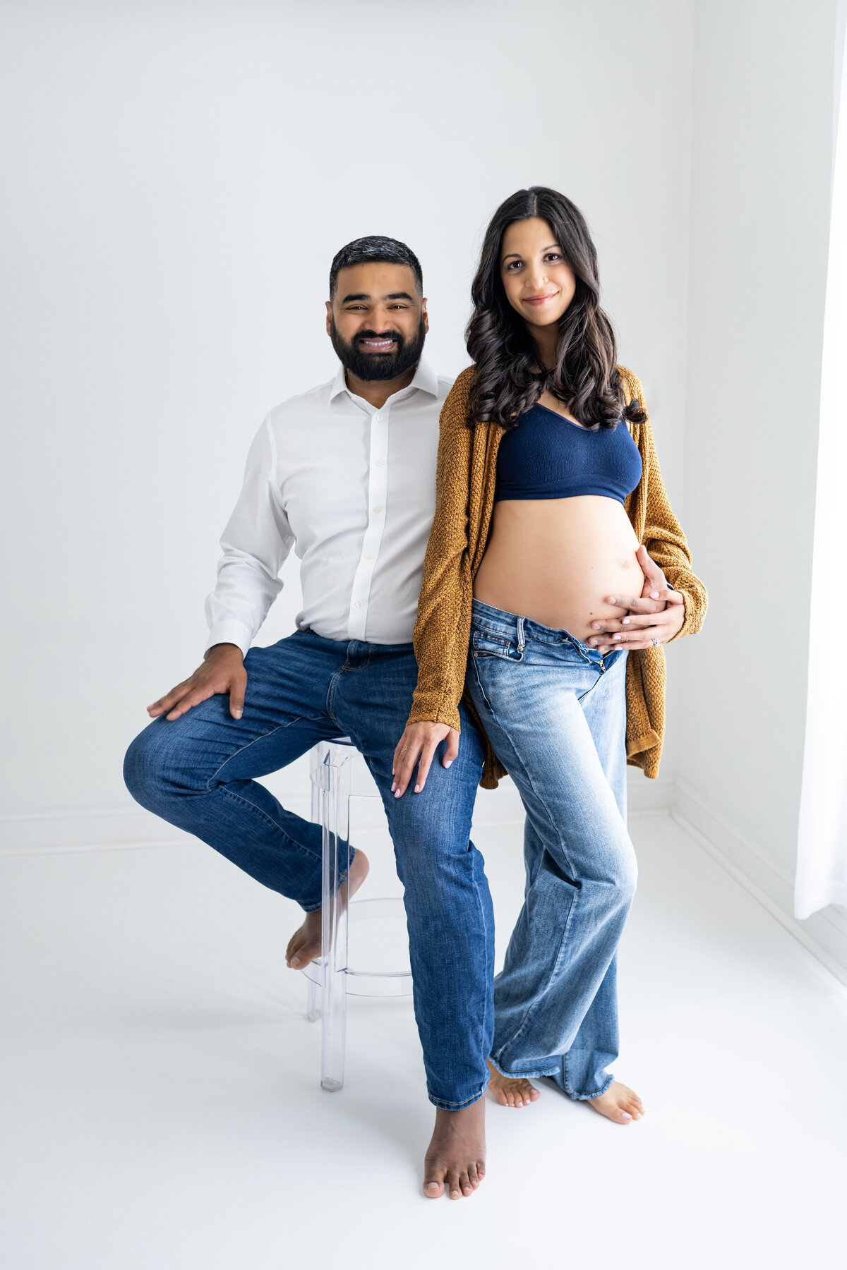 A husband and wife post for their maternity pictures