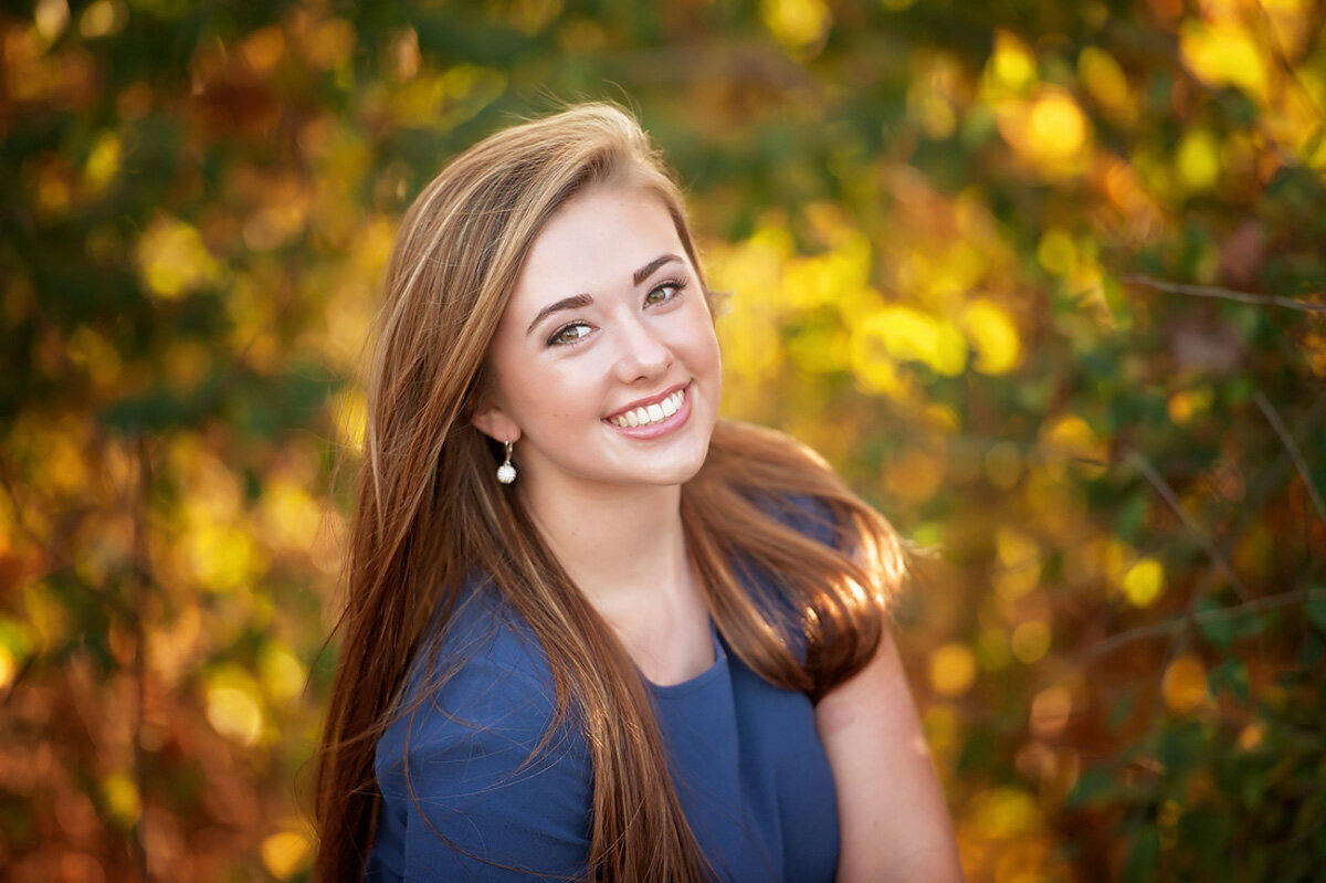 Senior session of young woman in a blue top