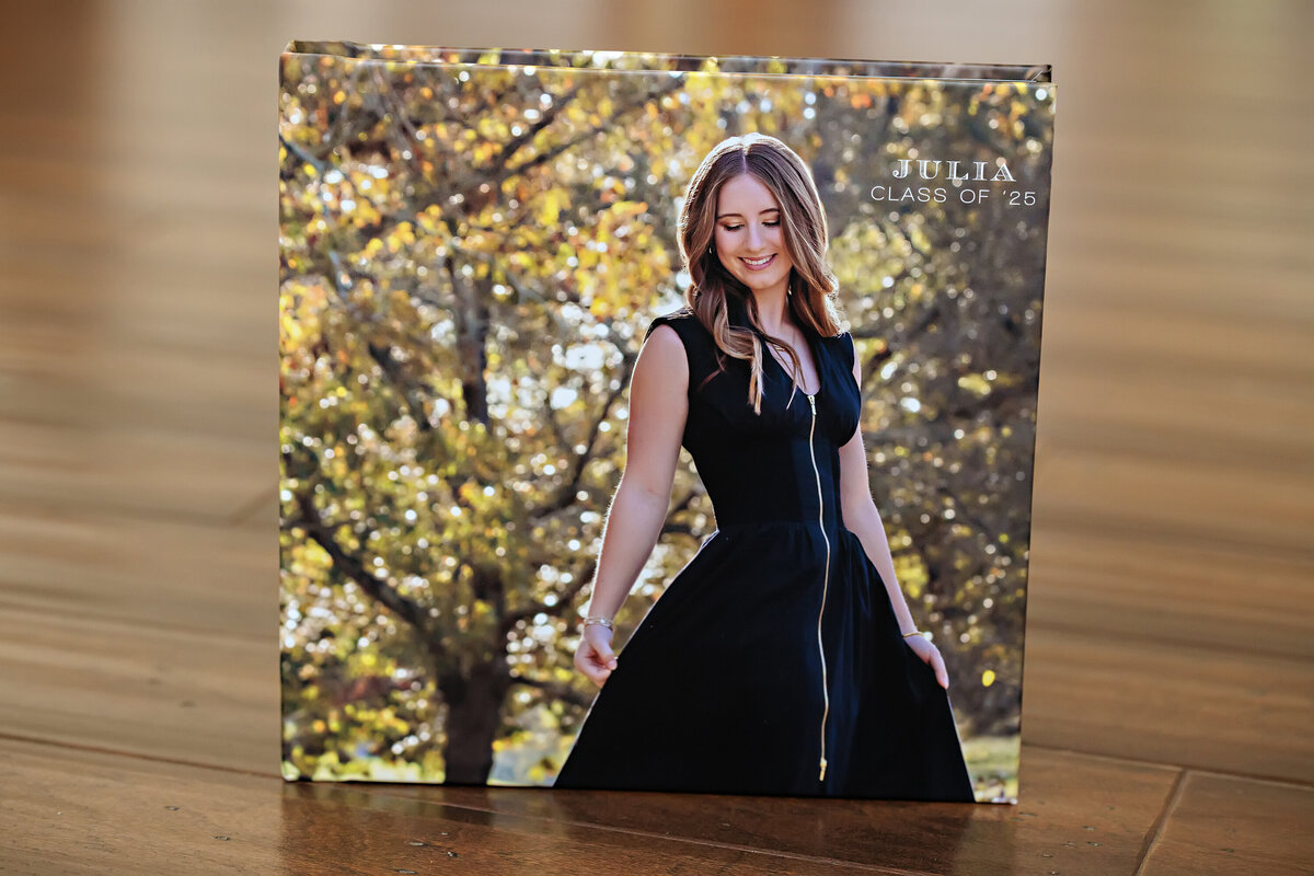 Custom Senior Session Book with Printed Memories standing on a tabletop