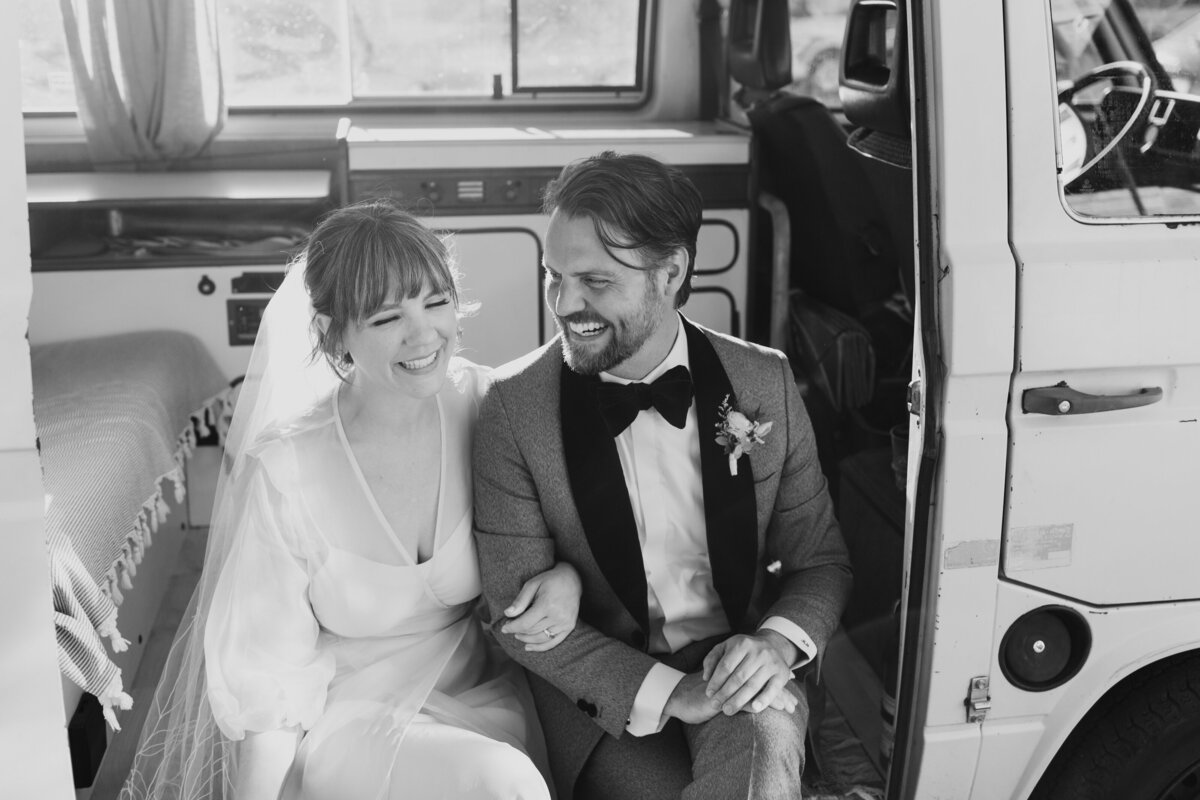 A couple in wedding attire sitting in a VW Westfalia captured by Fort Worth wedding photographer, Megan Christine Studio