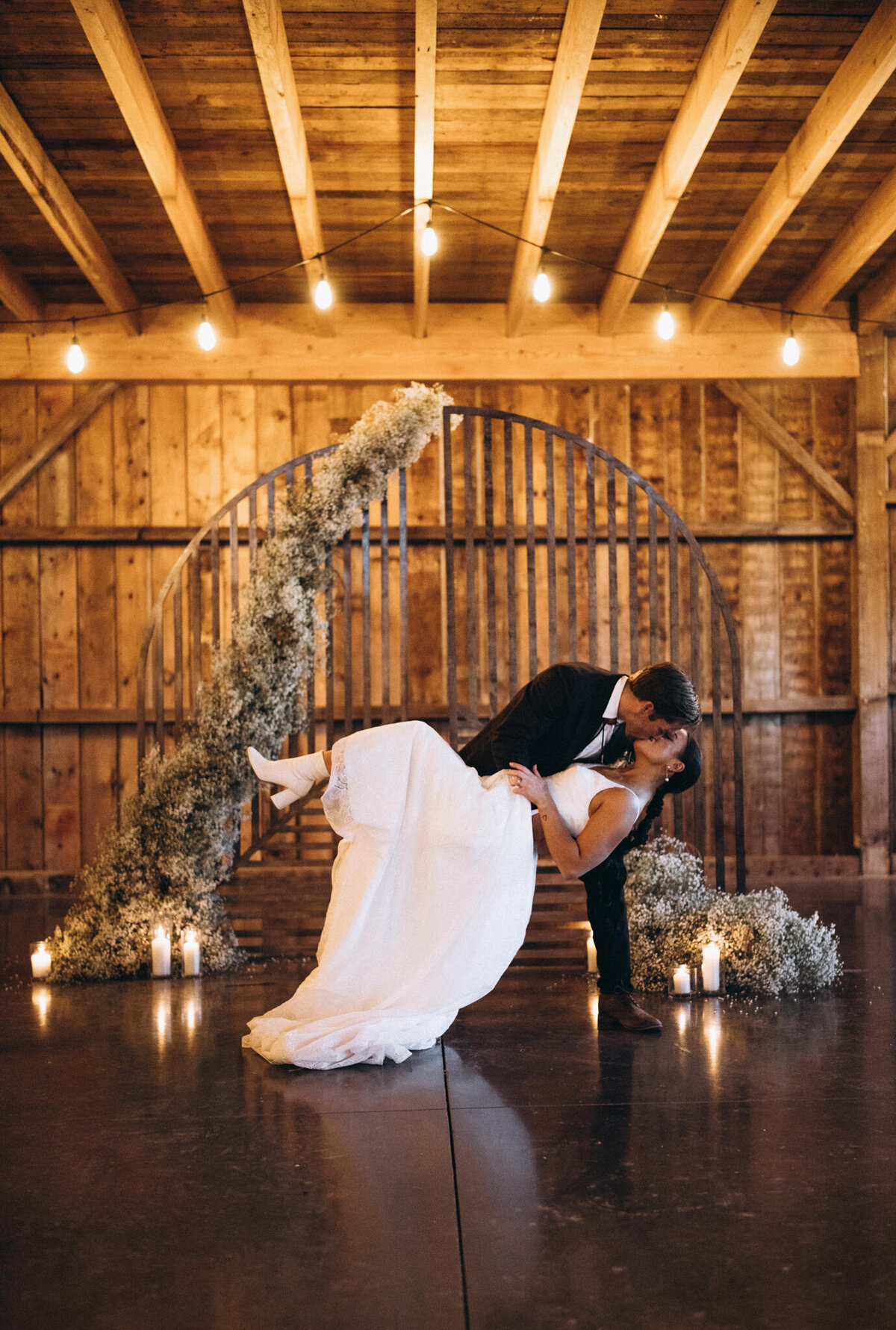 Indoor moody wedding ceremony at Countryside Barn, rustic, country Lethbridge, Alberta wedding venue, featured on the Brontë Bride Vendor Guide.