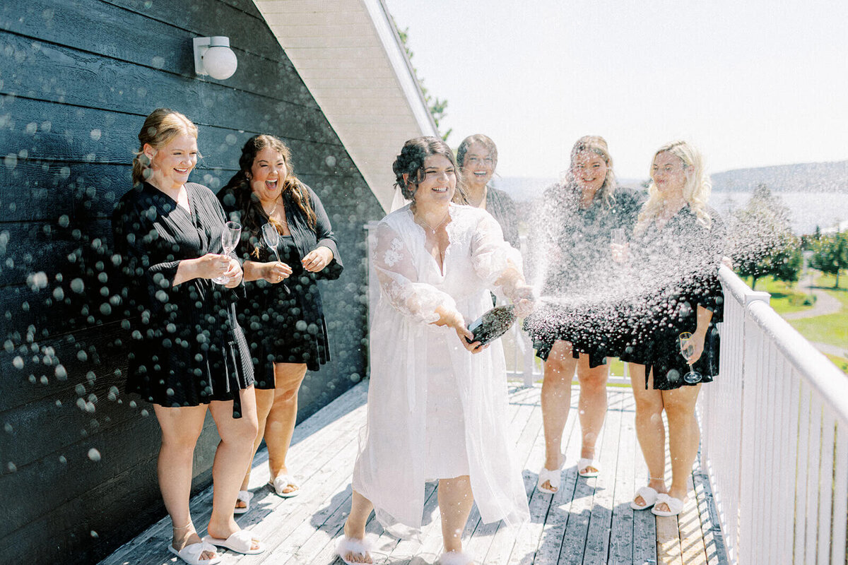 bride-and-bridesmaids-pop-the-bubbly