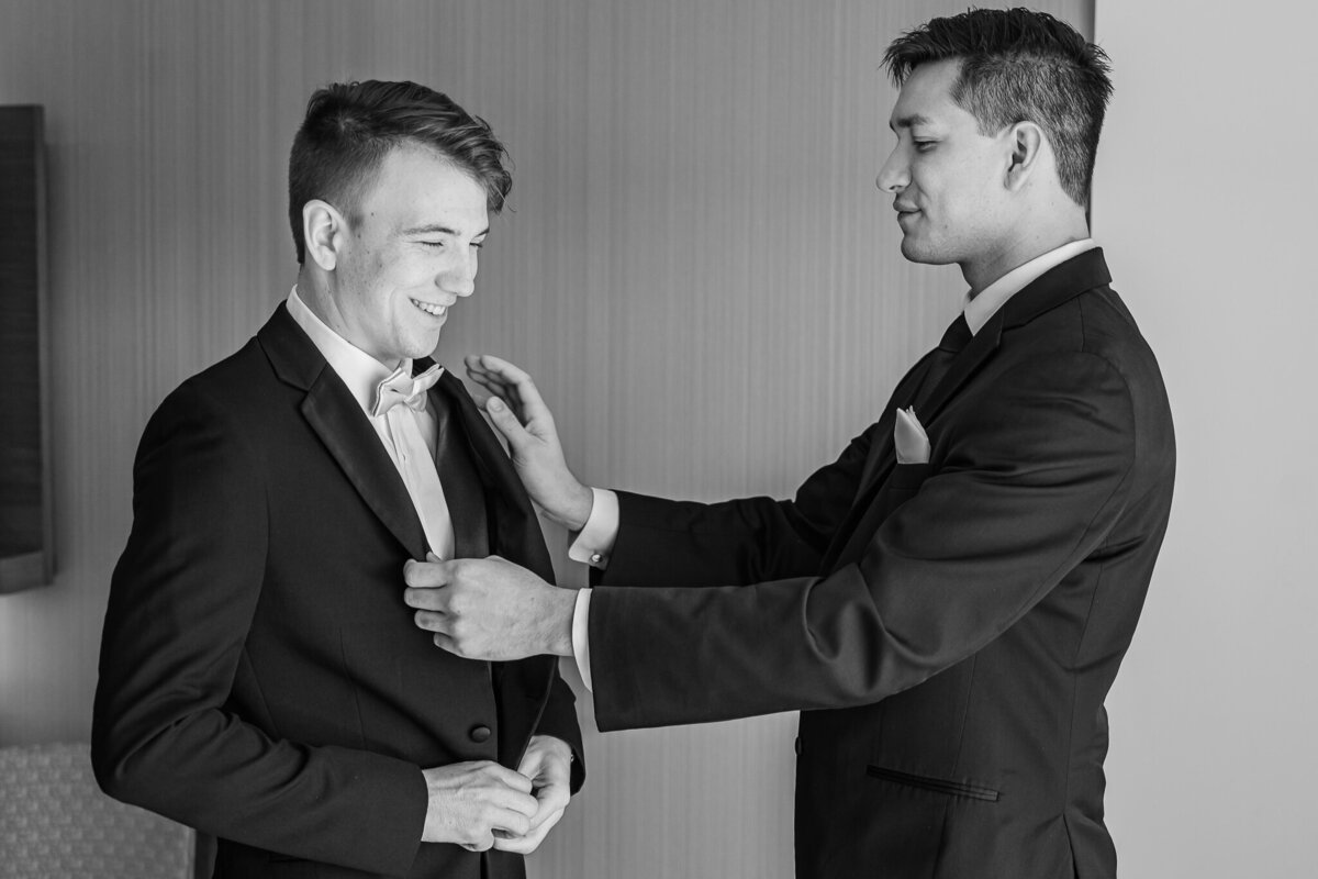 A groom getting ready with his best man on his wedding day in Cary by JoLynn Photography, a Raleigh wedding photographer