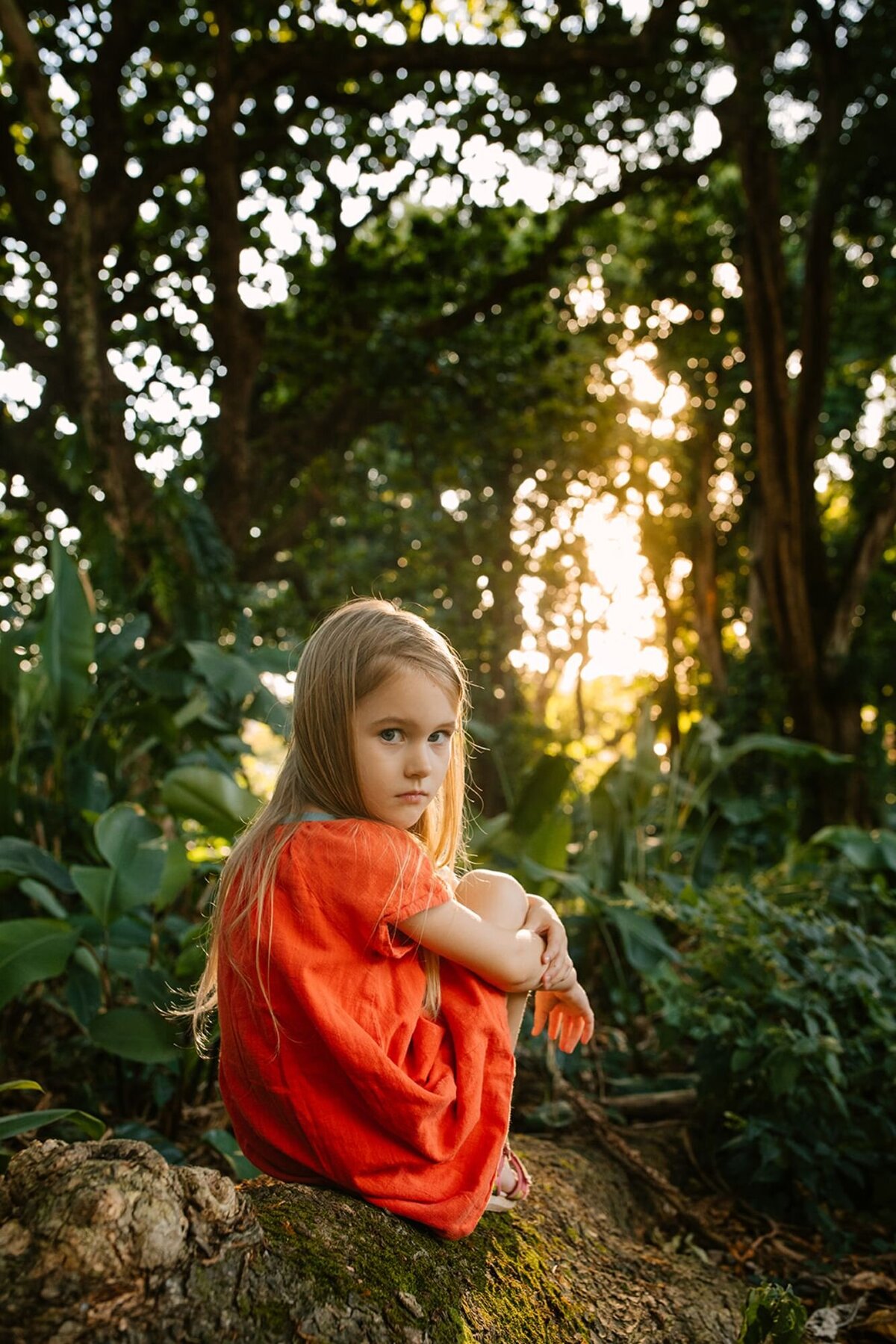 girl in orange dress at sunset in hawaii