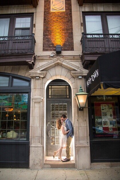 couple kissing in a doorway