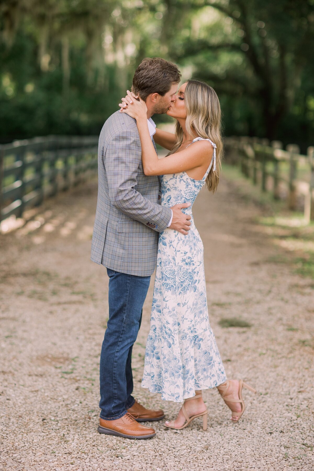 Couple kisses on tree lined path