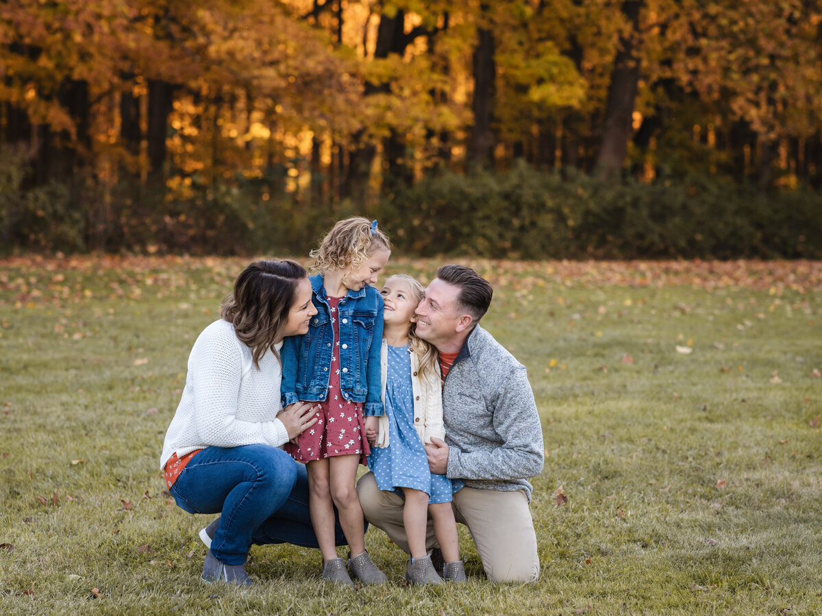 family posing for portraits at the park