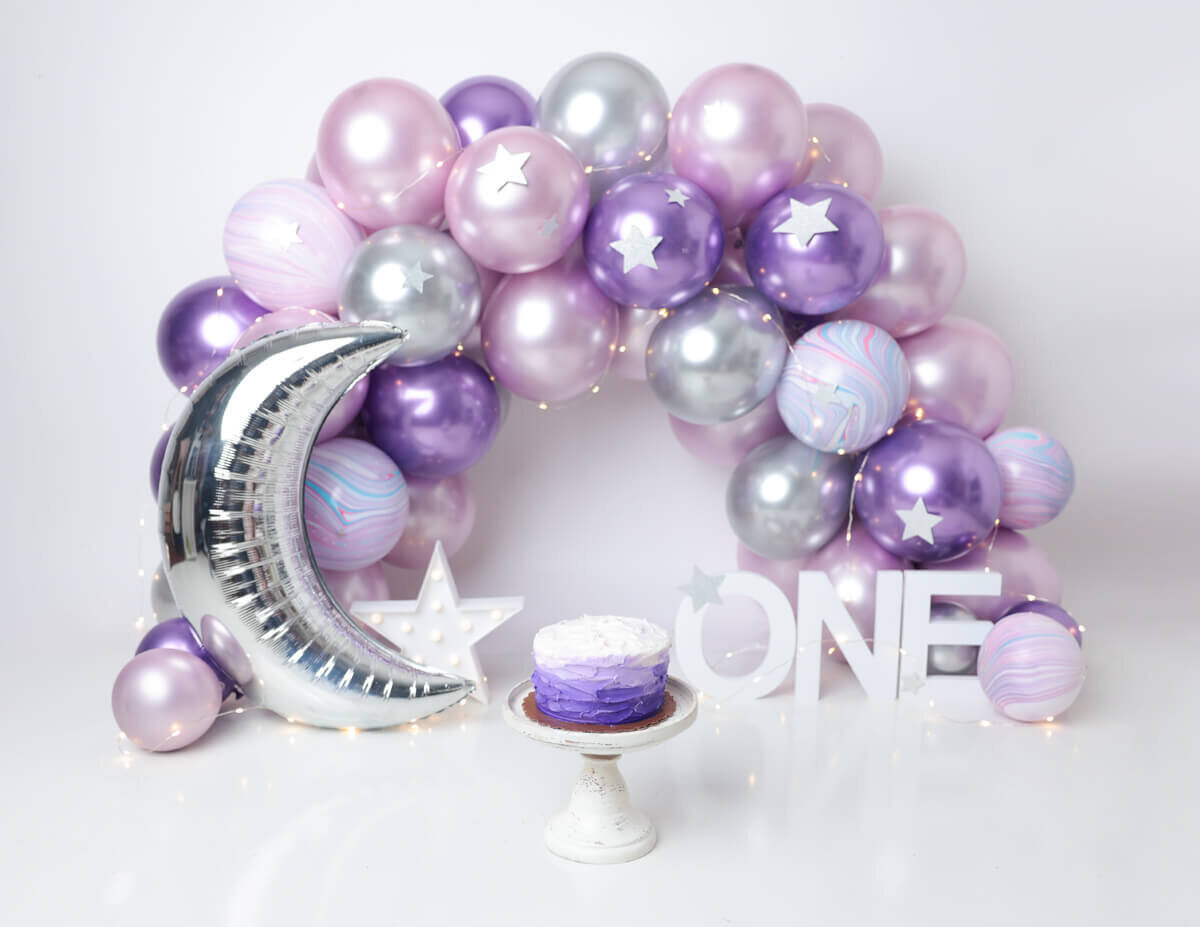 A playful assortment of balloons during a cake smash session in Rochester, NY