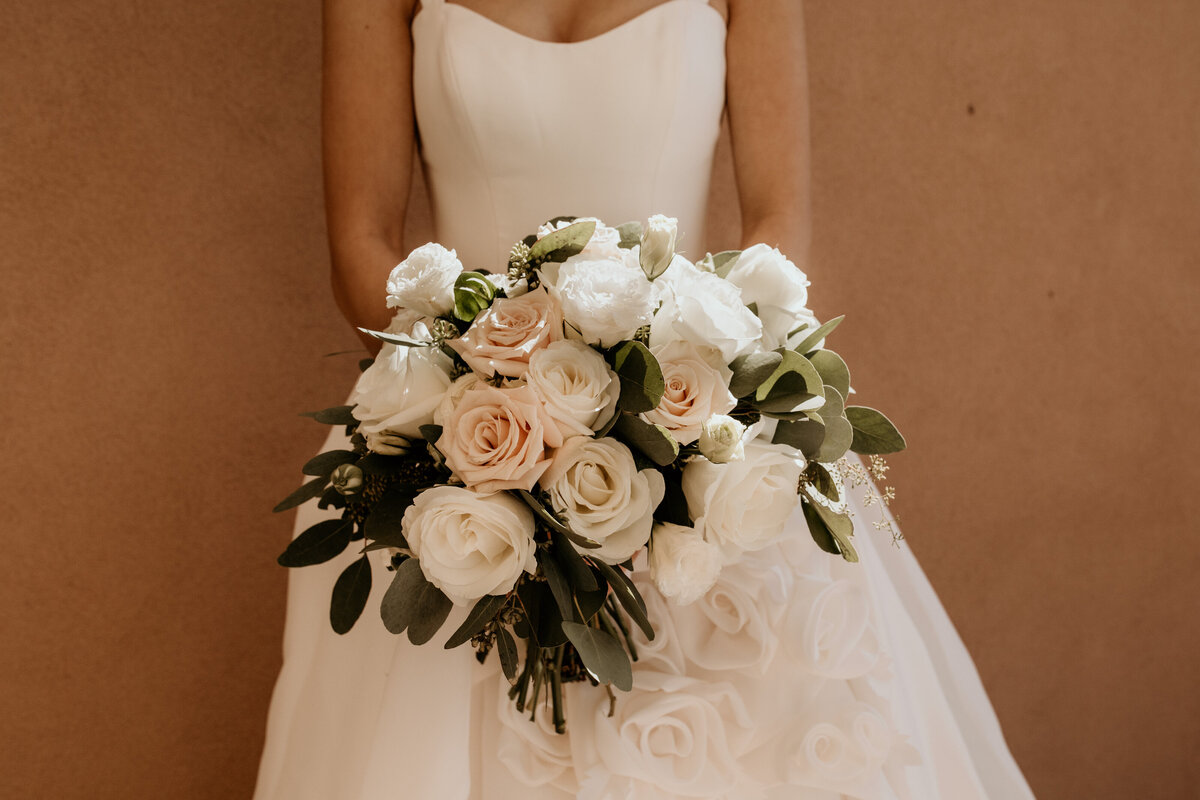 bride holding blush and white bouquet
