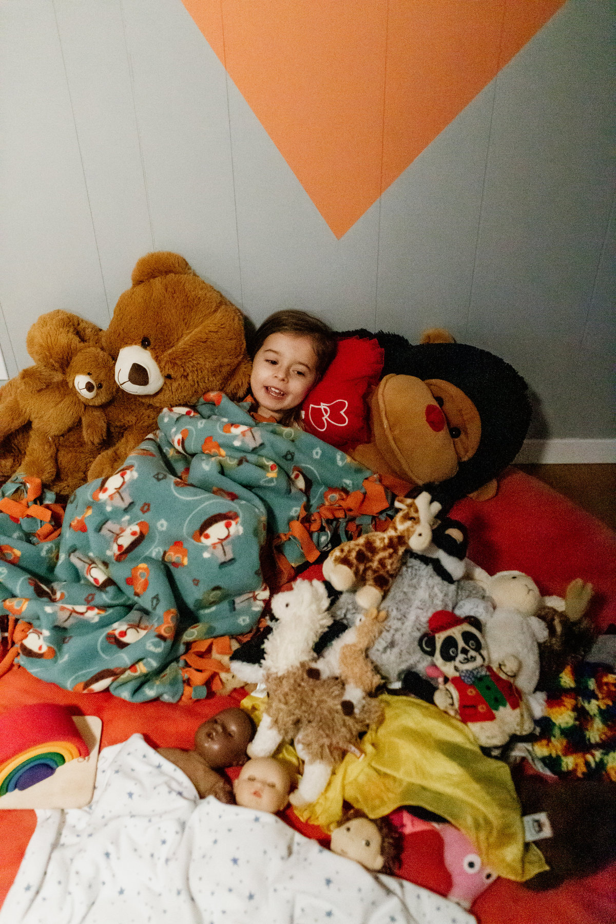 San Francisco child amidst pile of stuffed animals at in home family photography session