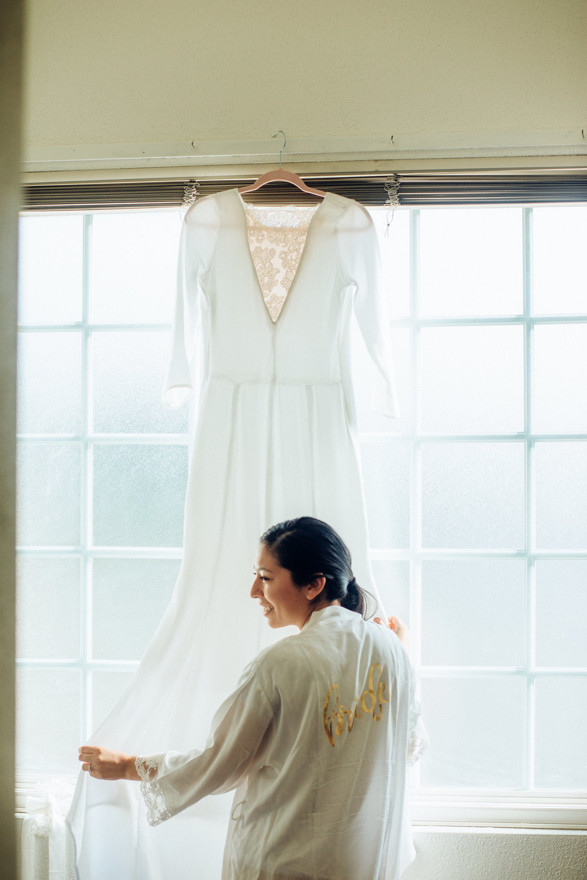 Wedding Photograph Of Woman in White Blouse Fixing White Dress Los Angeles