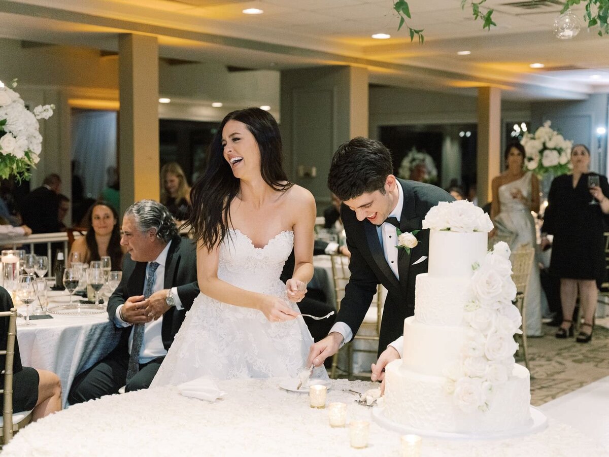 bride-and-groom-cutting-wedding-cake-with-sarah-sunstrom-photography-and-clementine-events
