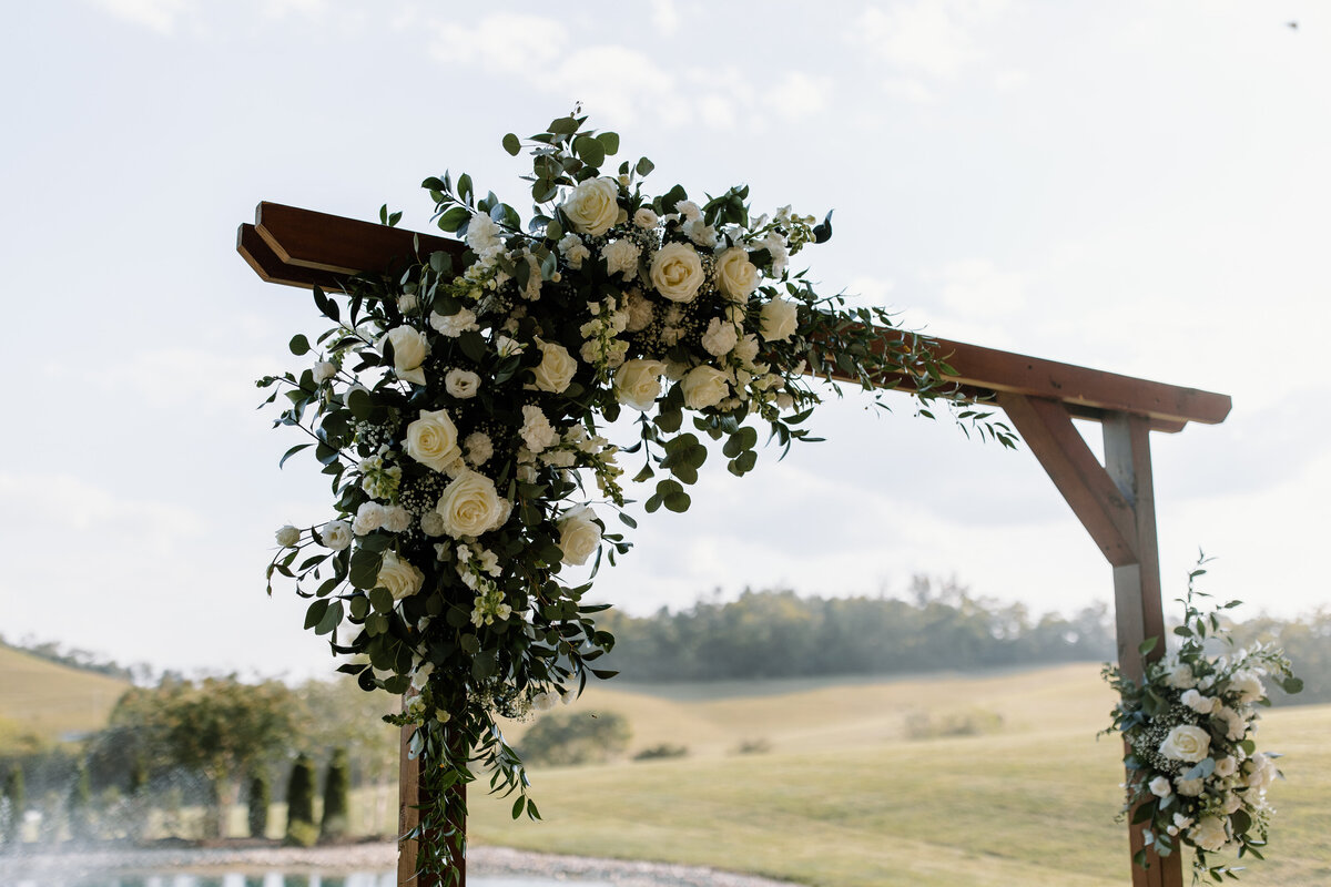 Detail photo of wedding arbor design of roses and greenery