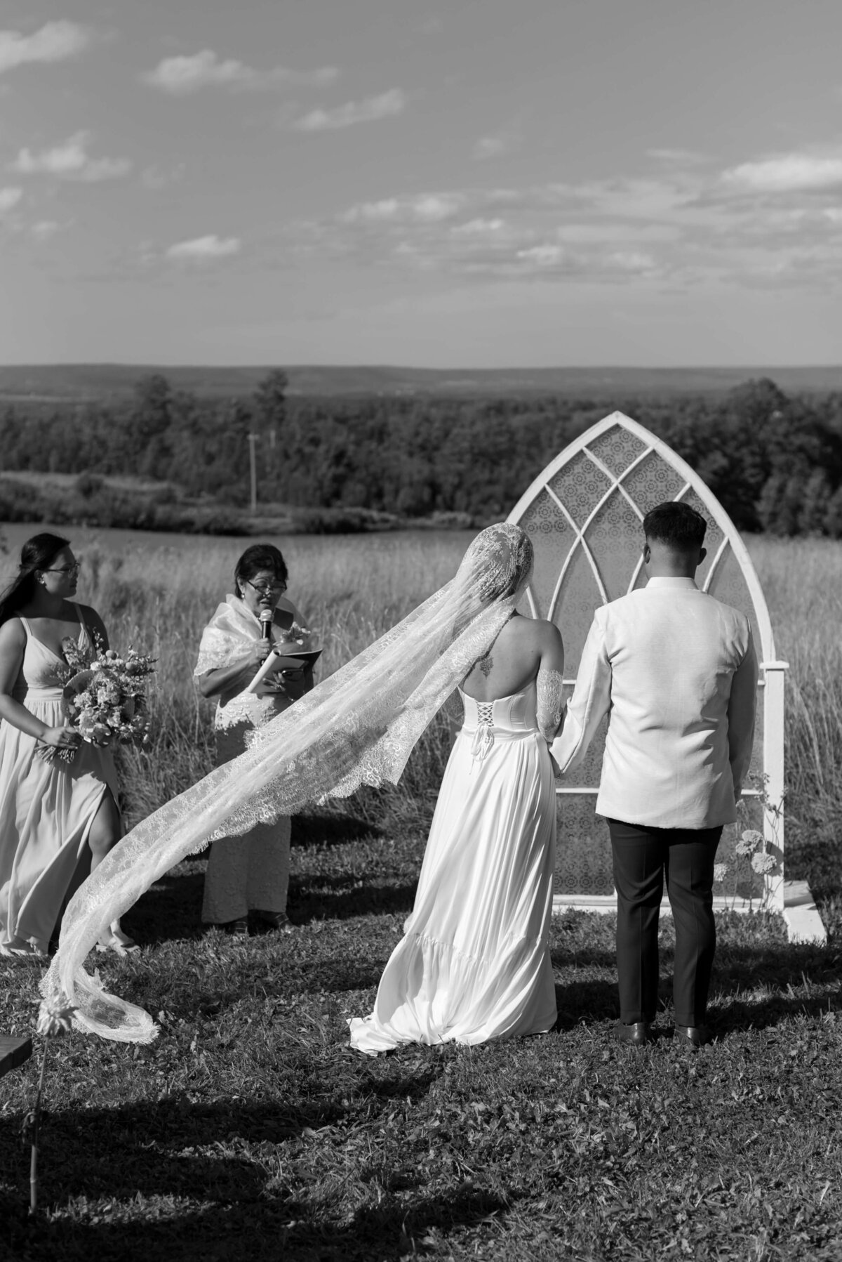 Bride and groom at wedding ceremony at Woodburn Ridge, Nova Scotia